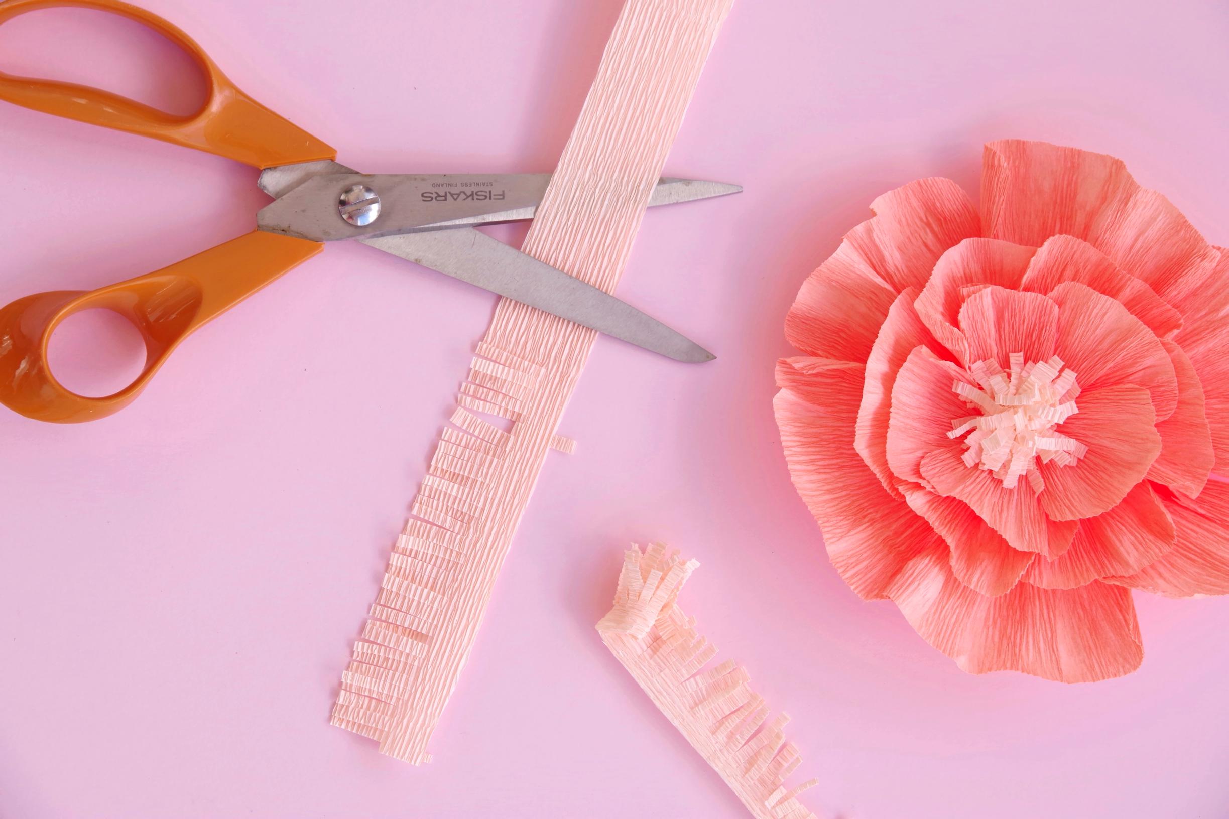 Create the flower center by fringing and rolling.