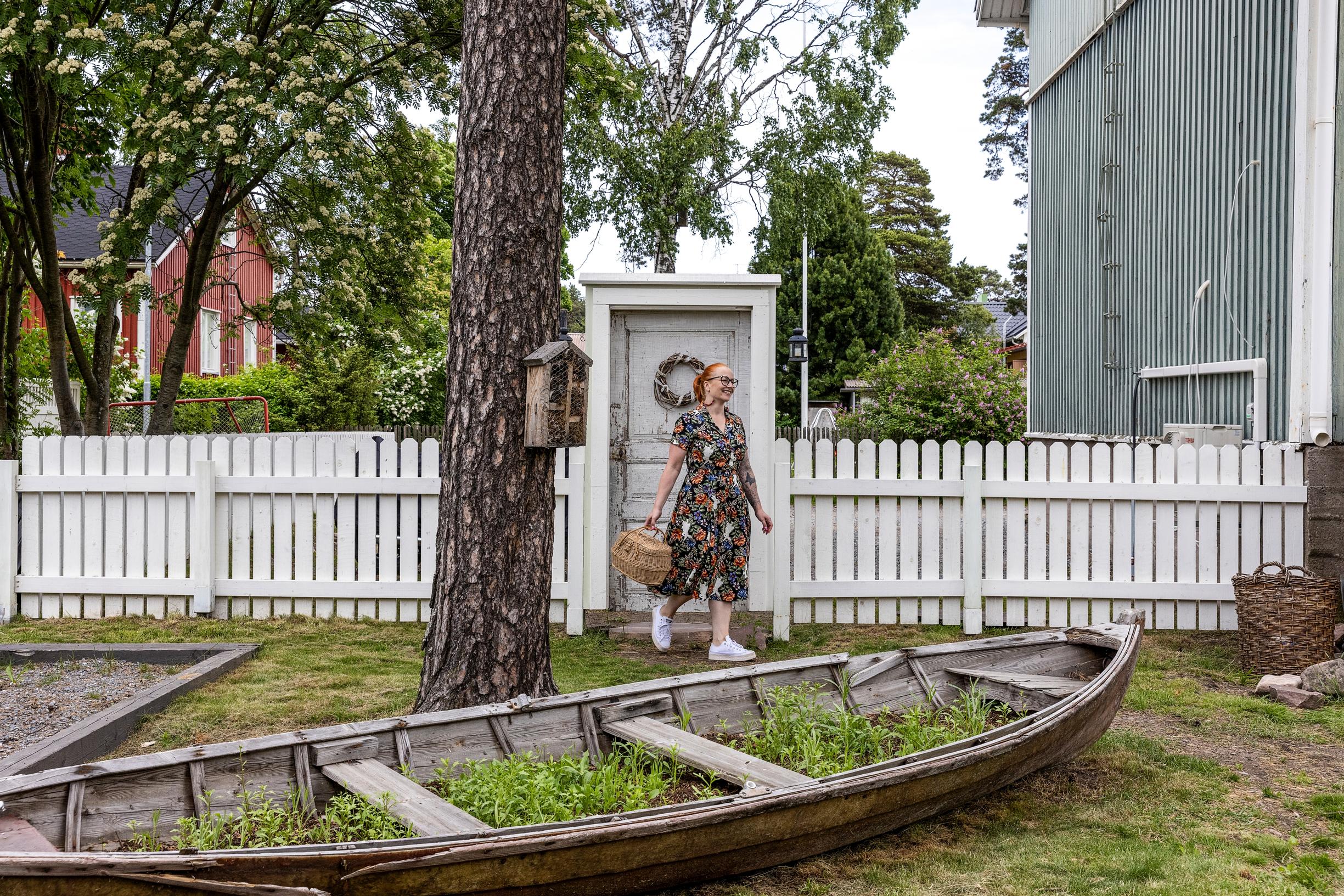 Hanna-Riikka in the yard of her home