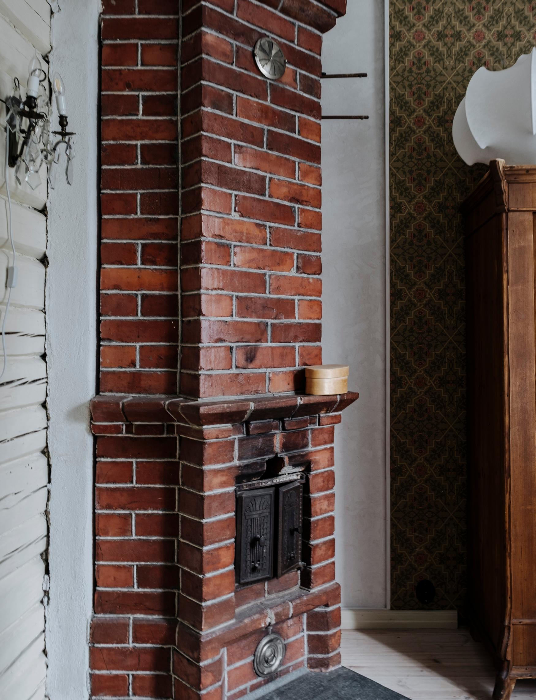 The bedroom’s red brick fireplace.