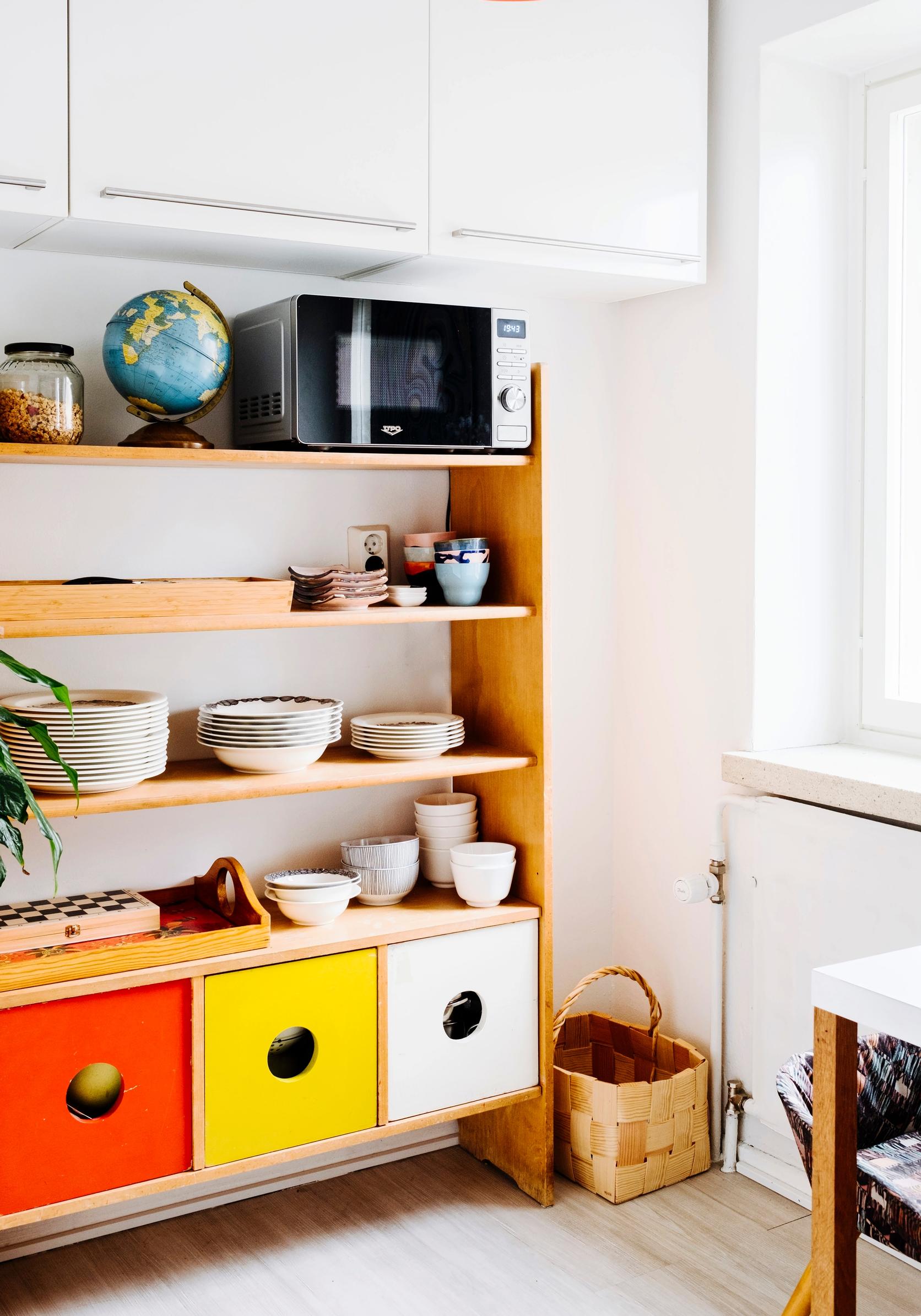 A colorful dish cabinet, originally a piece of children’s furniture