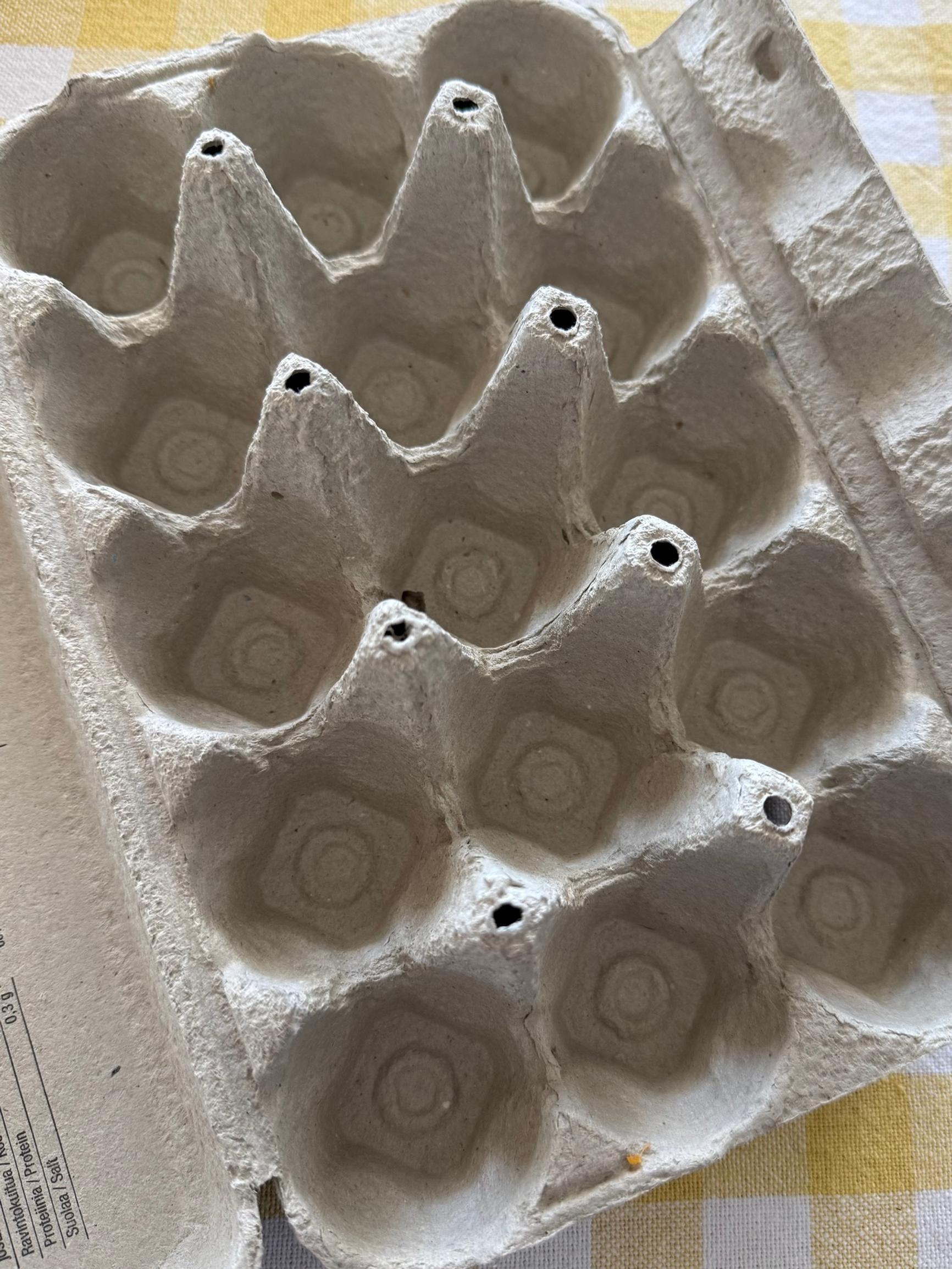 An empty egg carton on a table.