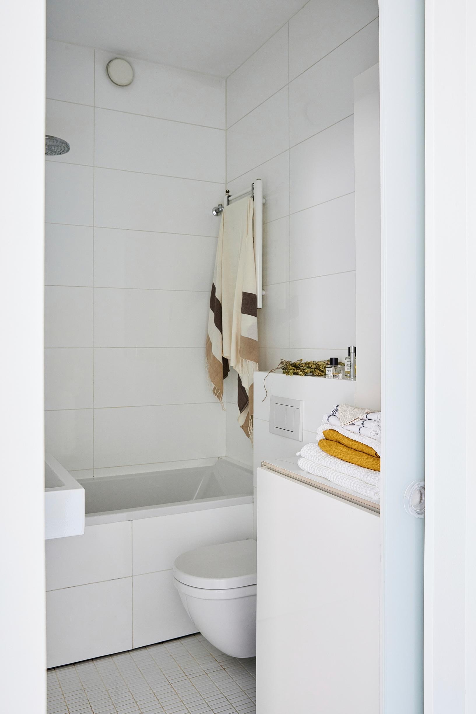All surfaces in the modernized bathroom are white.