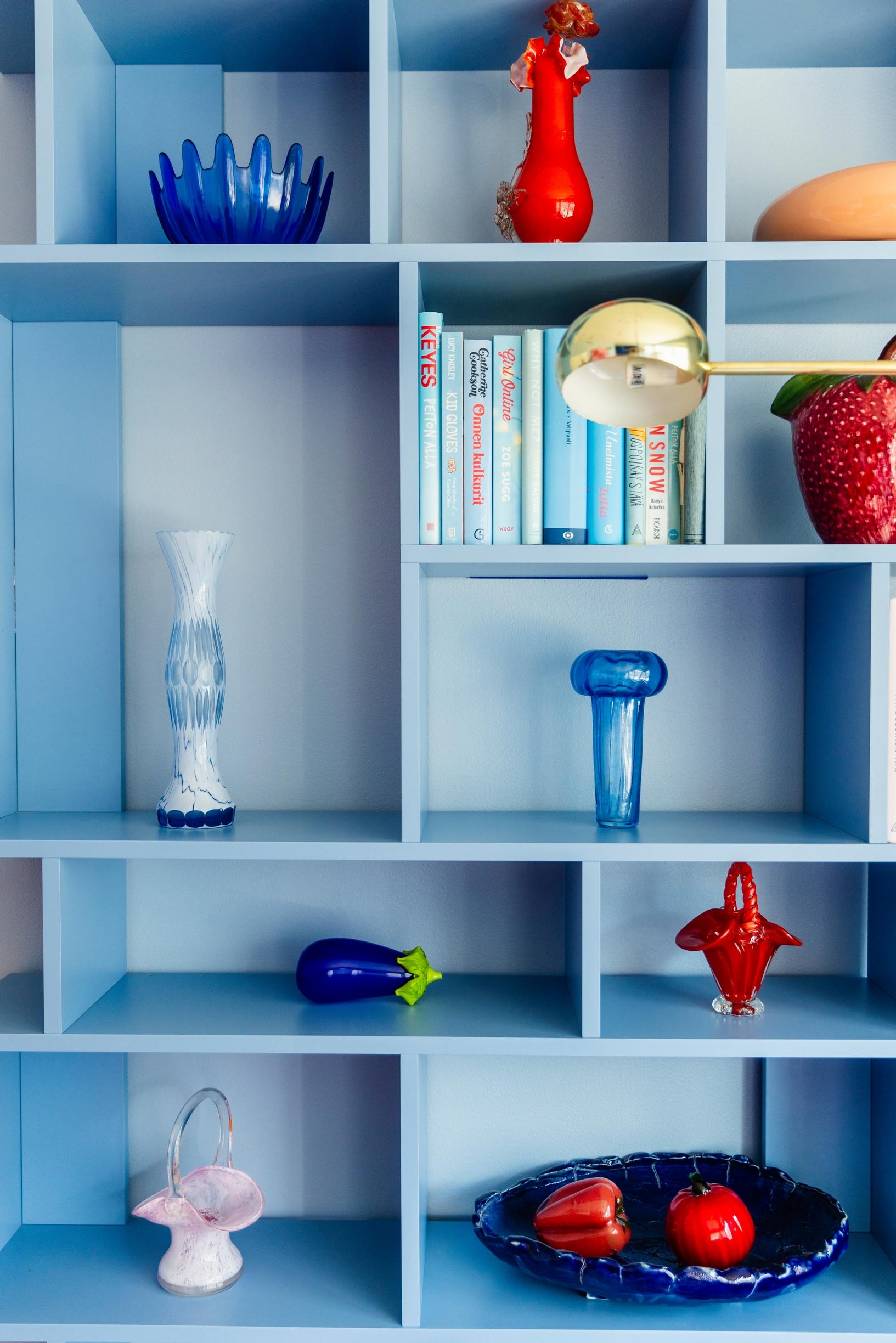 a blue bookshelf and blue and red objects