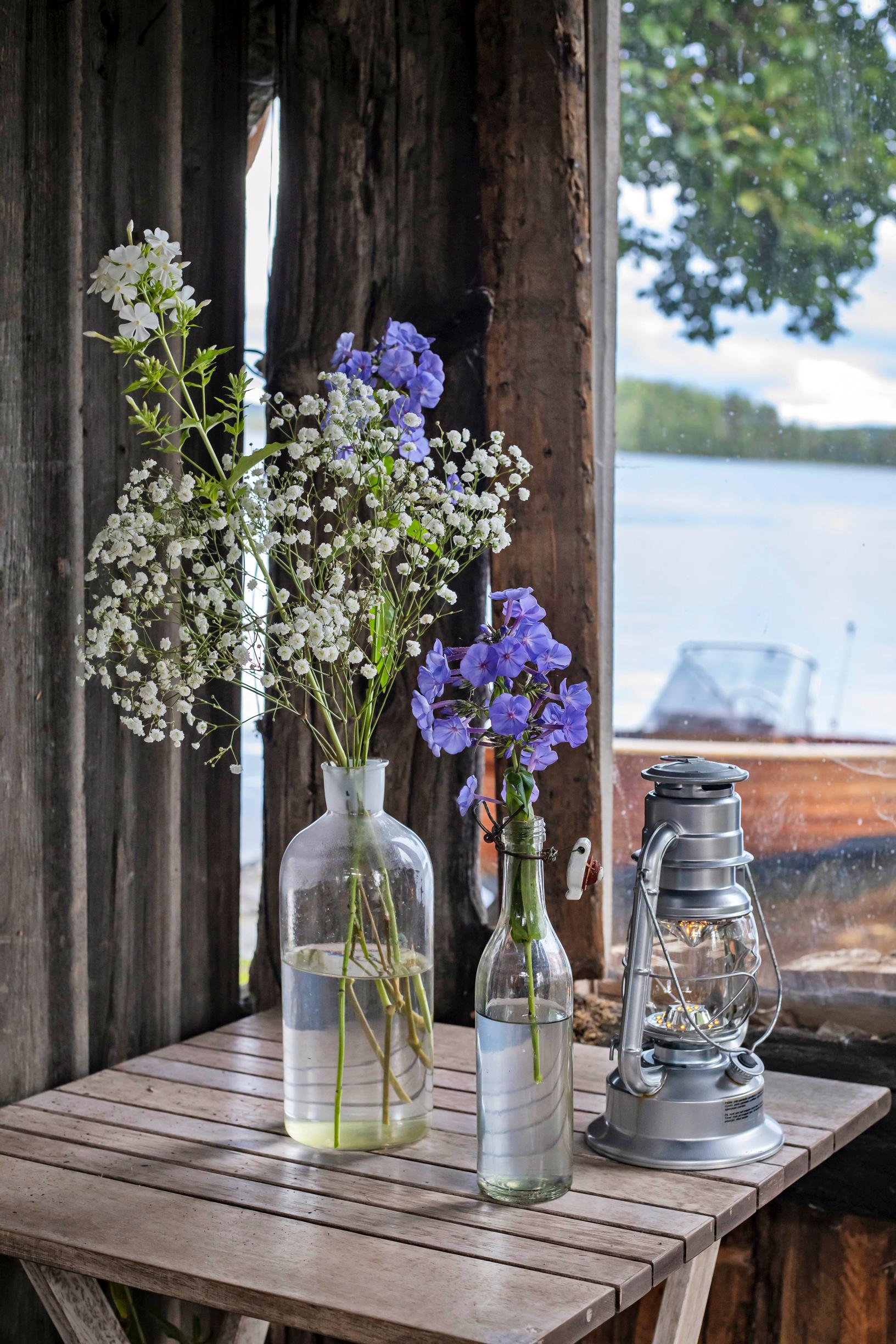Wildflowers and baby’s breath in glass bottles