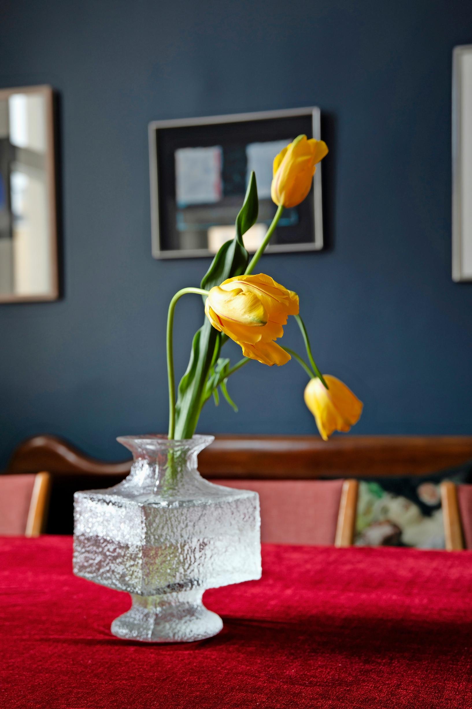 An angular glass vase on the dining table.