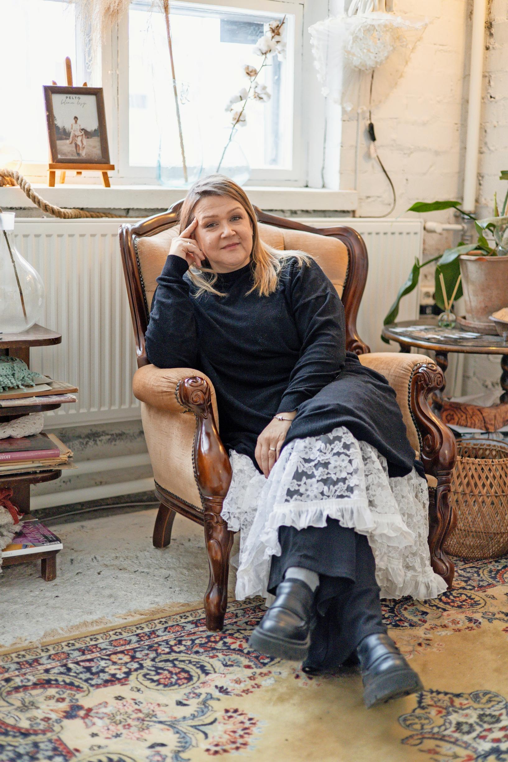 Mari Ketosalmi sitting on a chair in her studio.