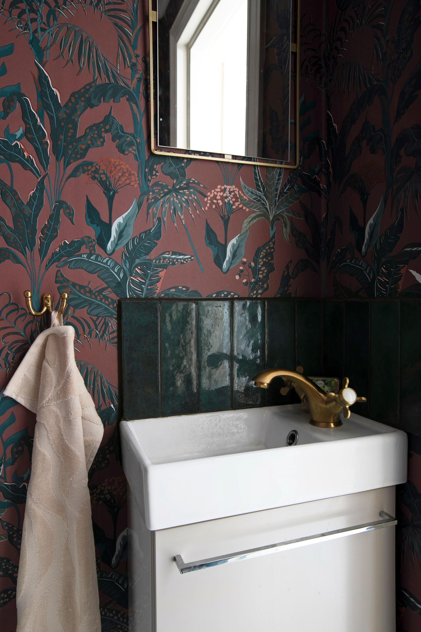 WC refreshed affordably with leftover tiles and a dramatic wallpaper