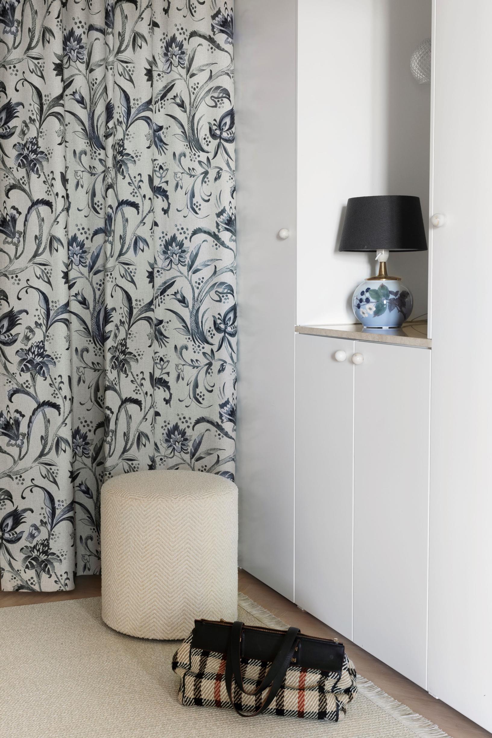 In the hallway, the door has been replaced with a thick curtain and a storage cabinet.