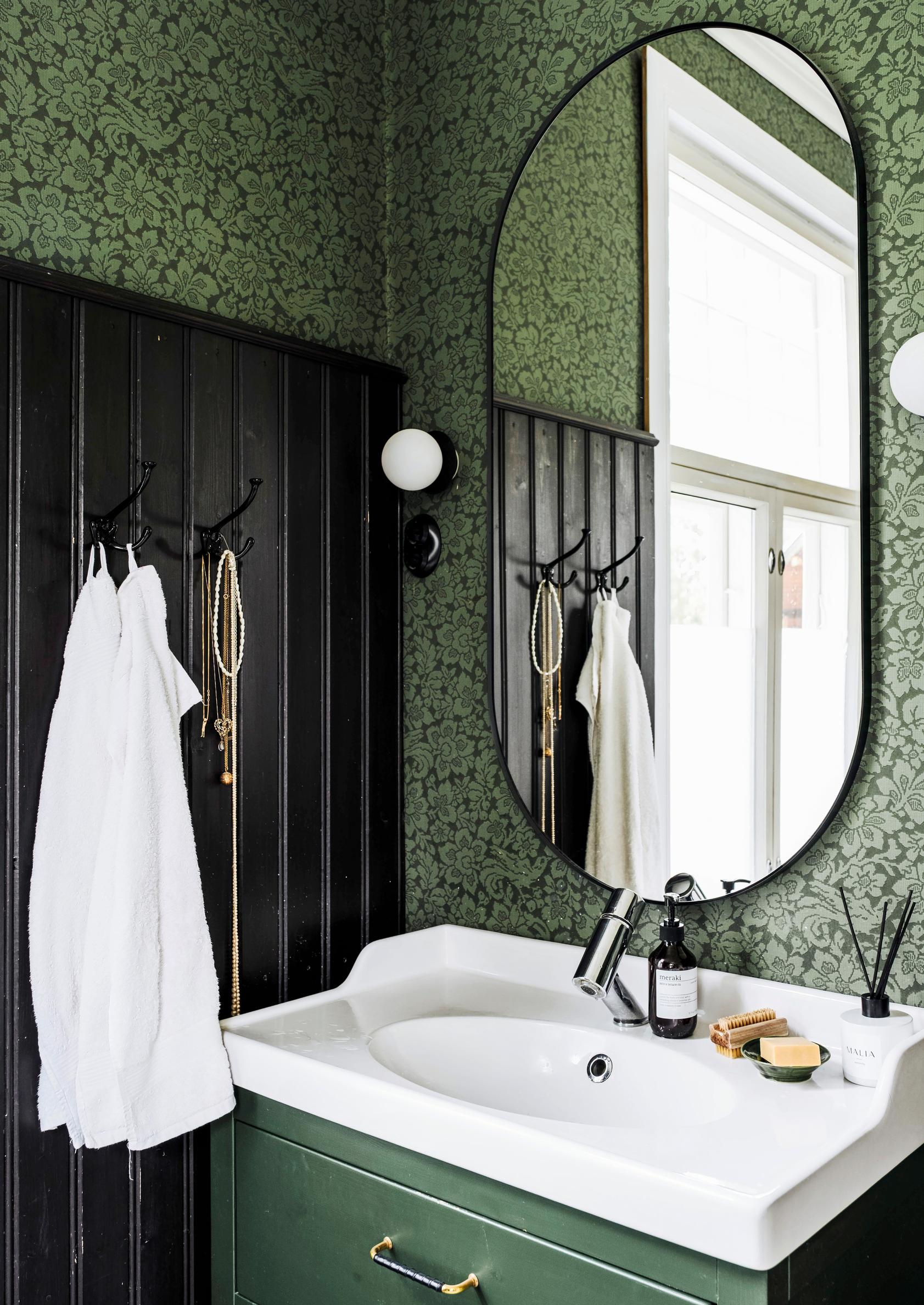 Sohvi refurbished an old Ikea sink cabinet and painted it forest green.