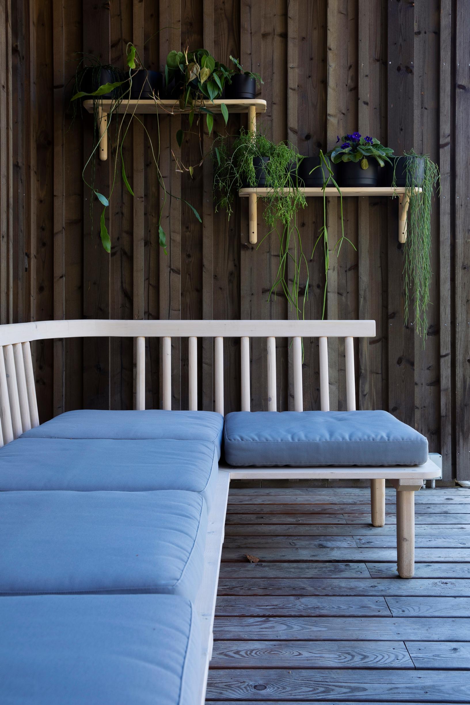 A homemade corner sofa and plant shelf on the terrace