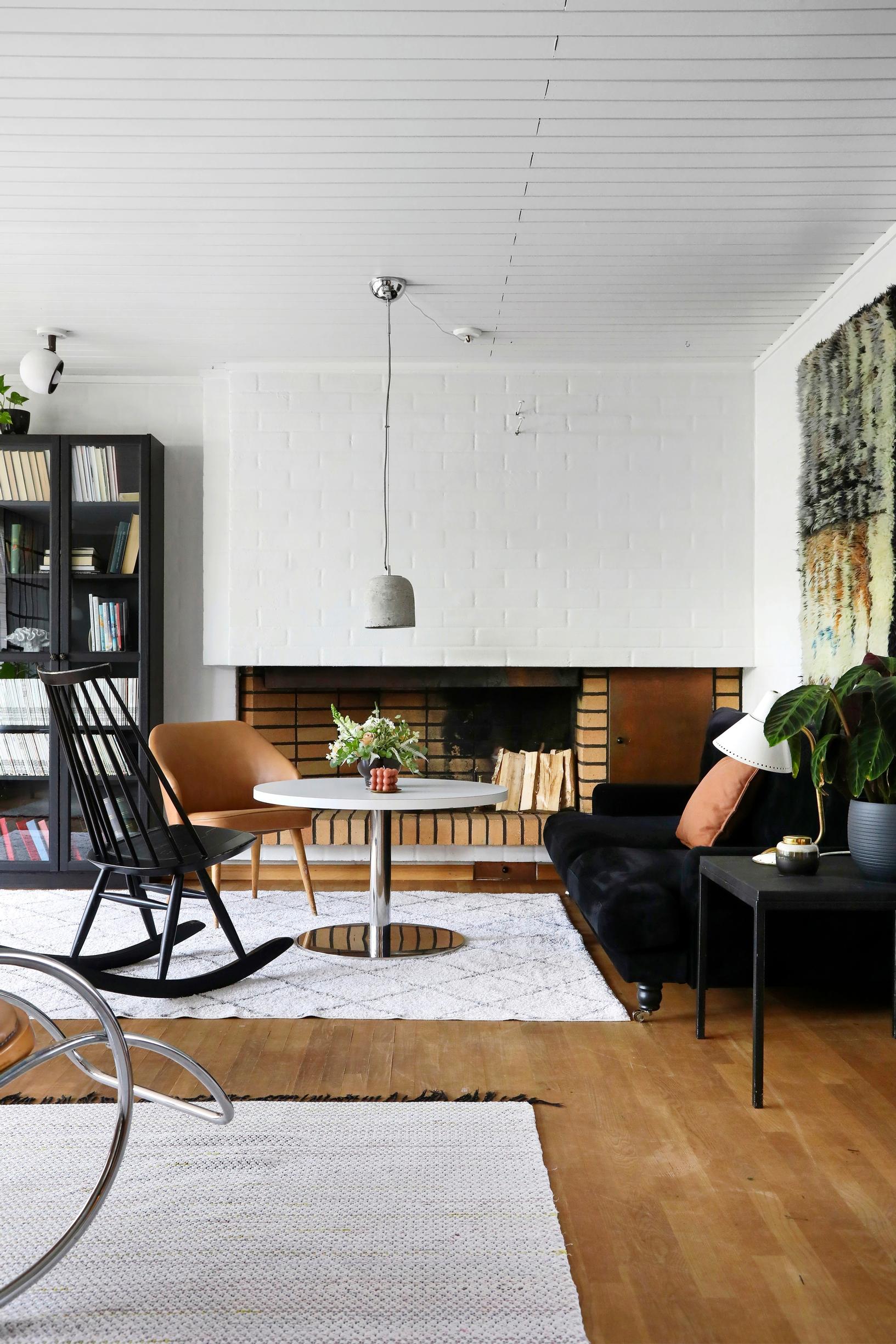 Photo of the open fireplace and seating area with vintage furniture.