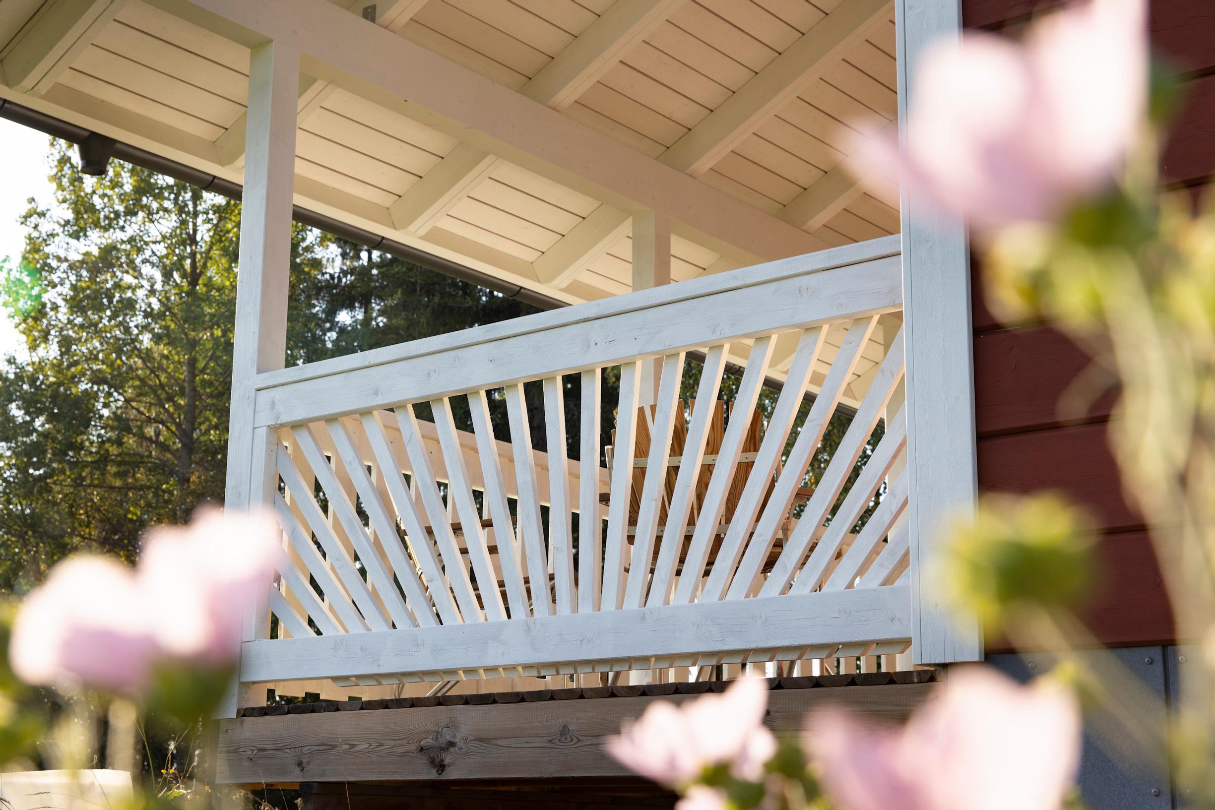 Wooden terrace railings with slats arranged in a fan shape.