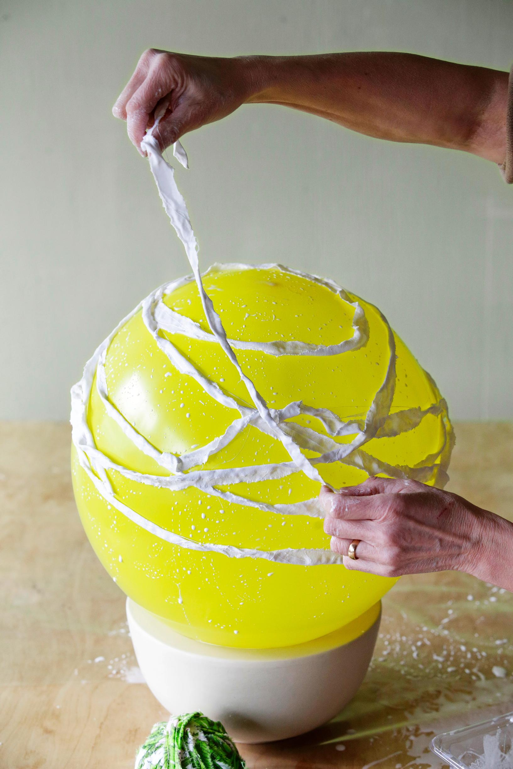 Placing fabric strips on top of the balloon