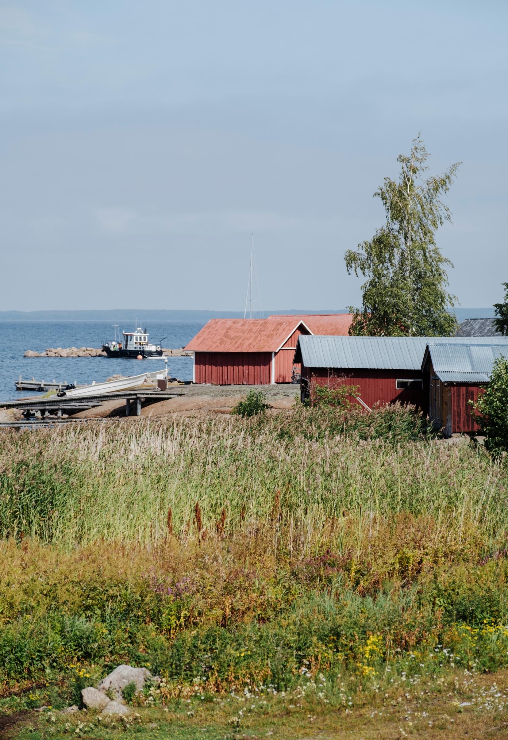 The village environment of Tammio island in Hamina with red boathouses