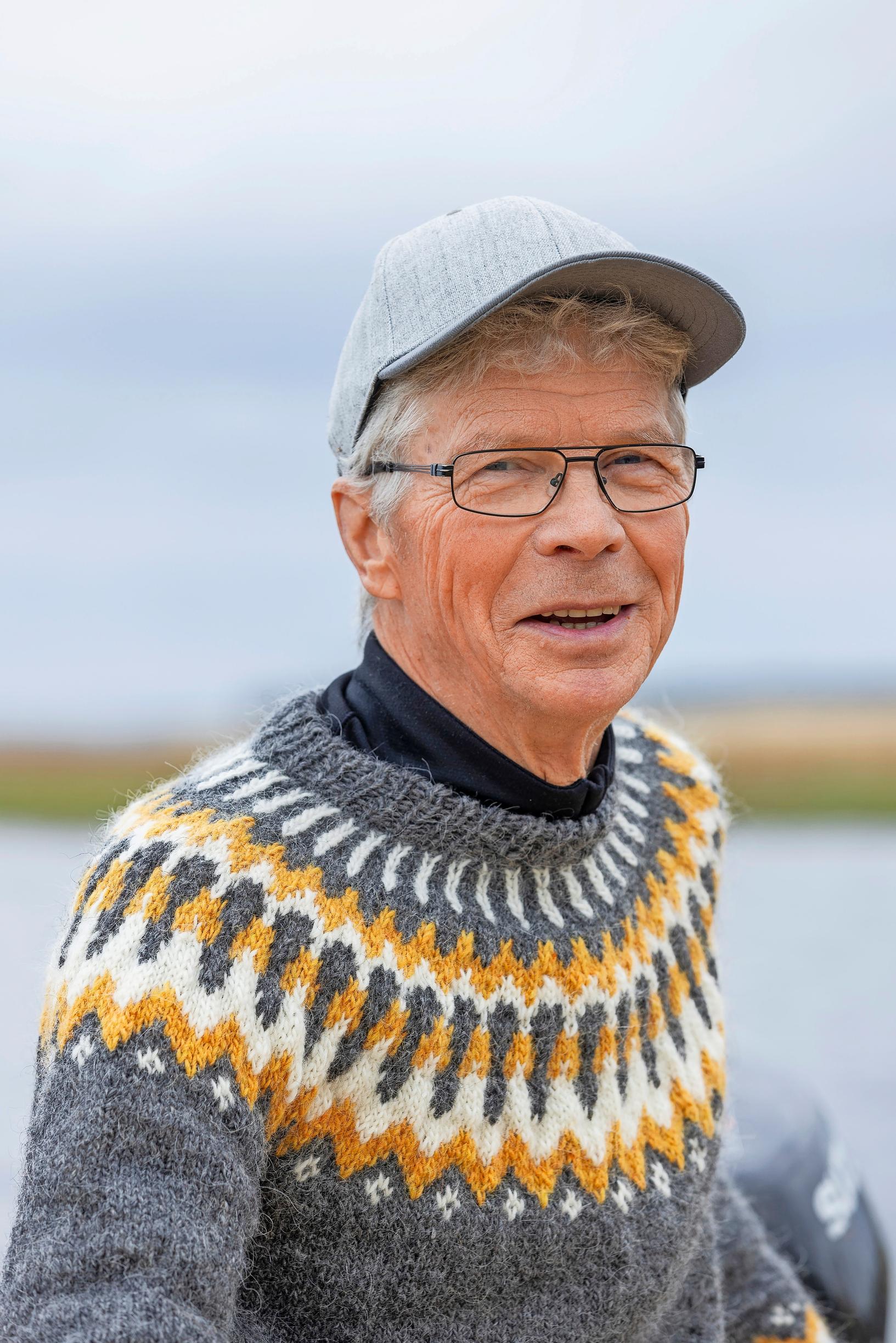 Aimo Taljavirta wearing a colorful wool sweater and a baseball cap