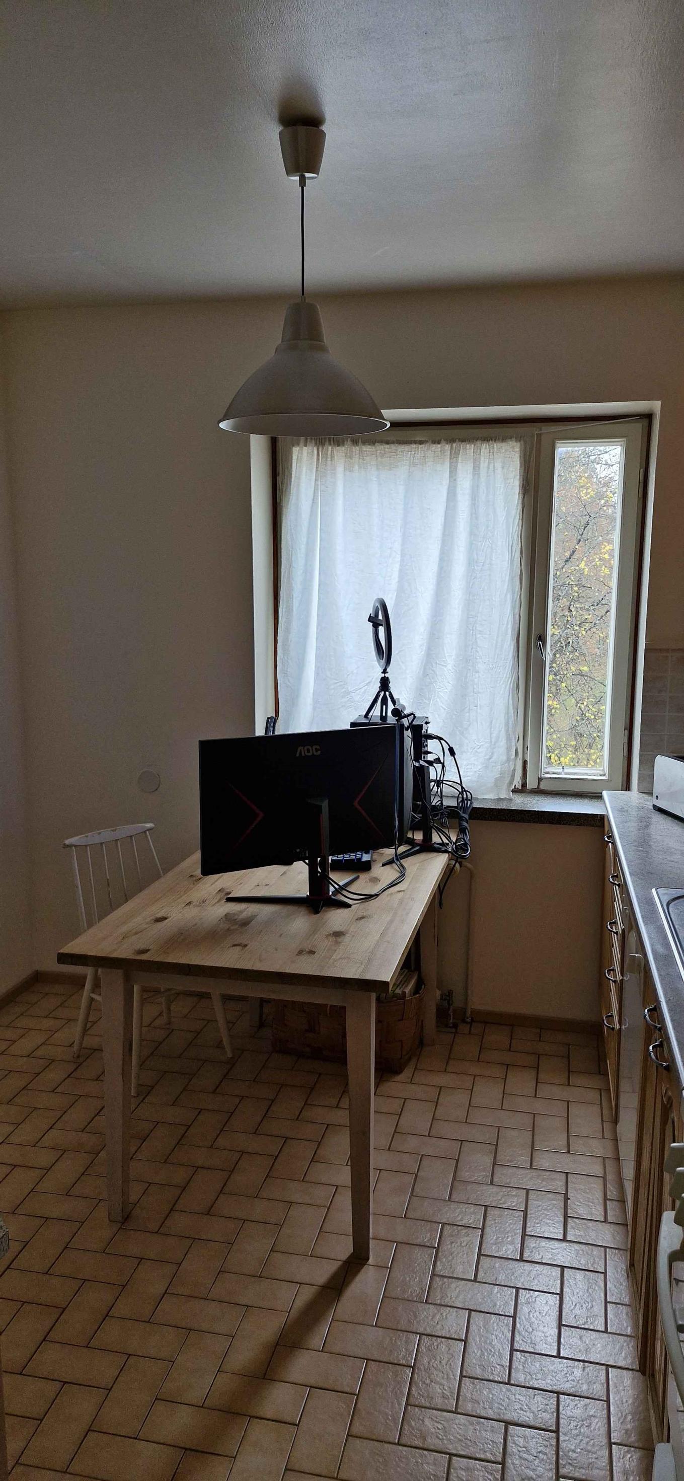 kitchen table with a computer screen