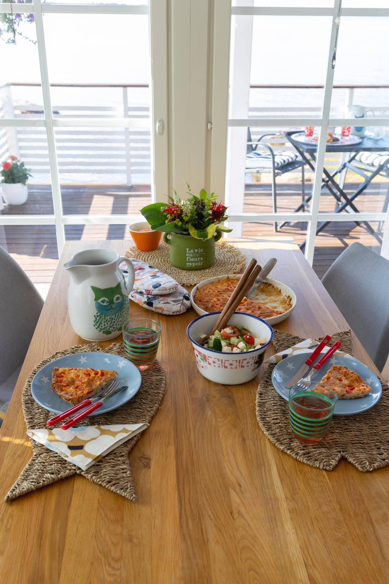 place settings on the dining table, terrace visible through the window