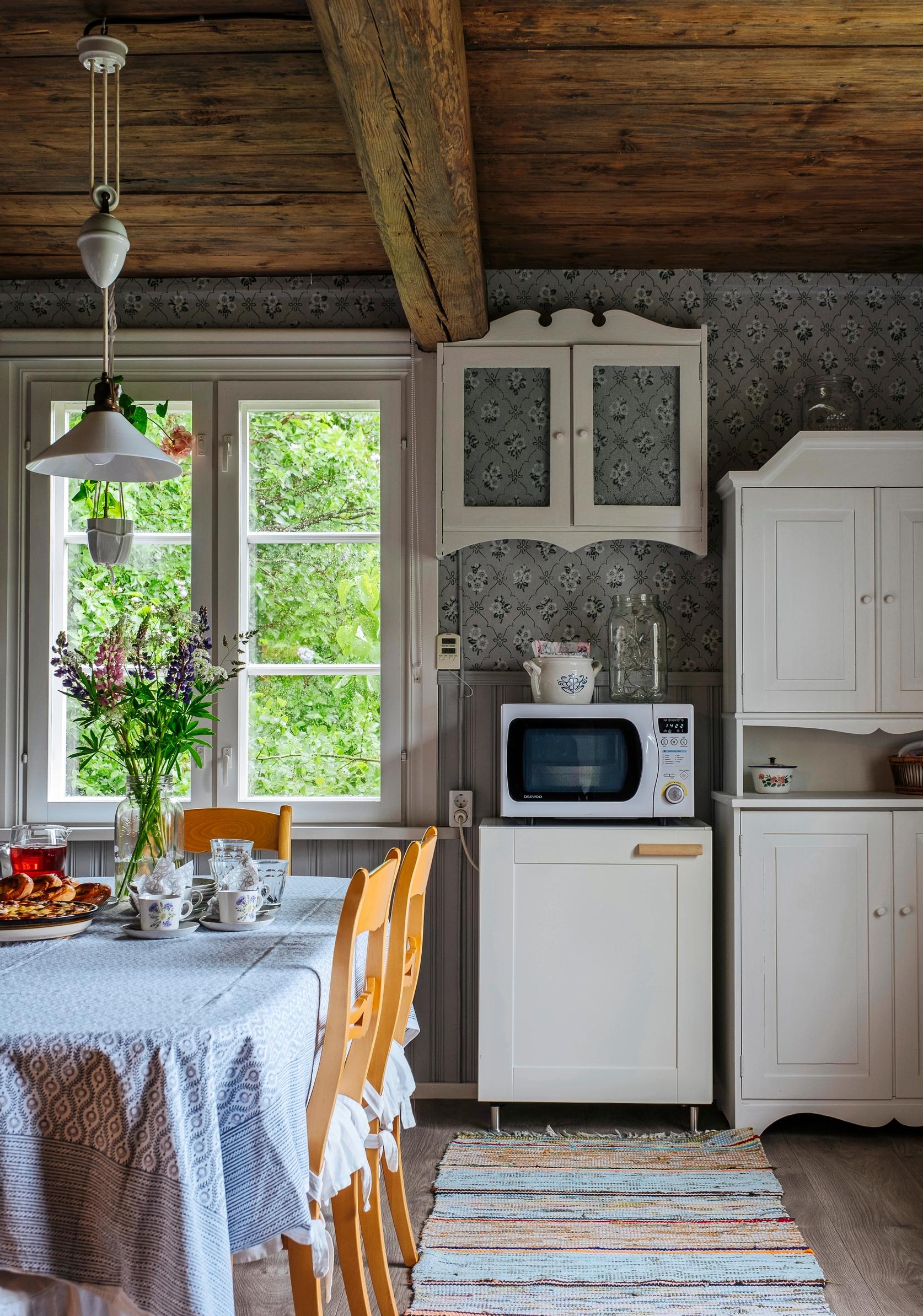 Kitchen with a lush view through its paned window