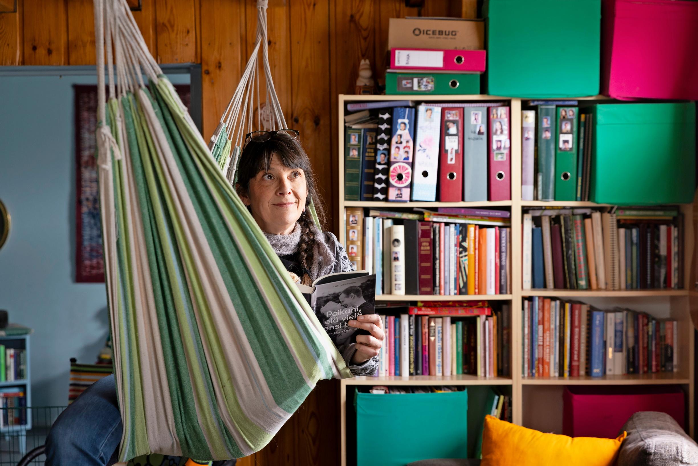 a woman in a hammock in a living room