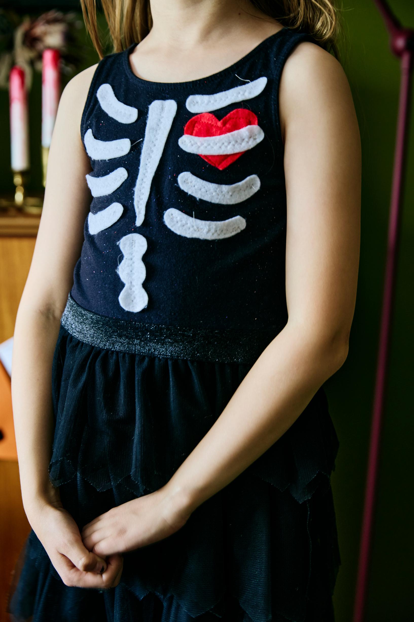 Child wearing a skeleton dress.