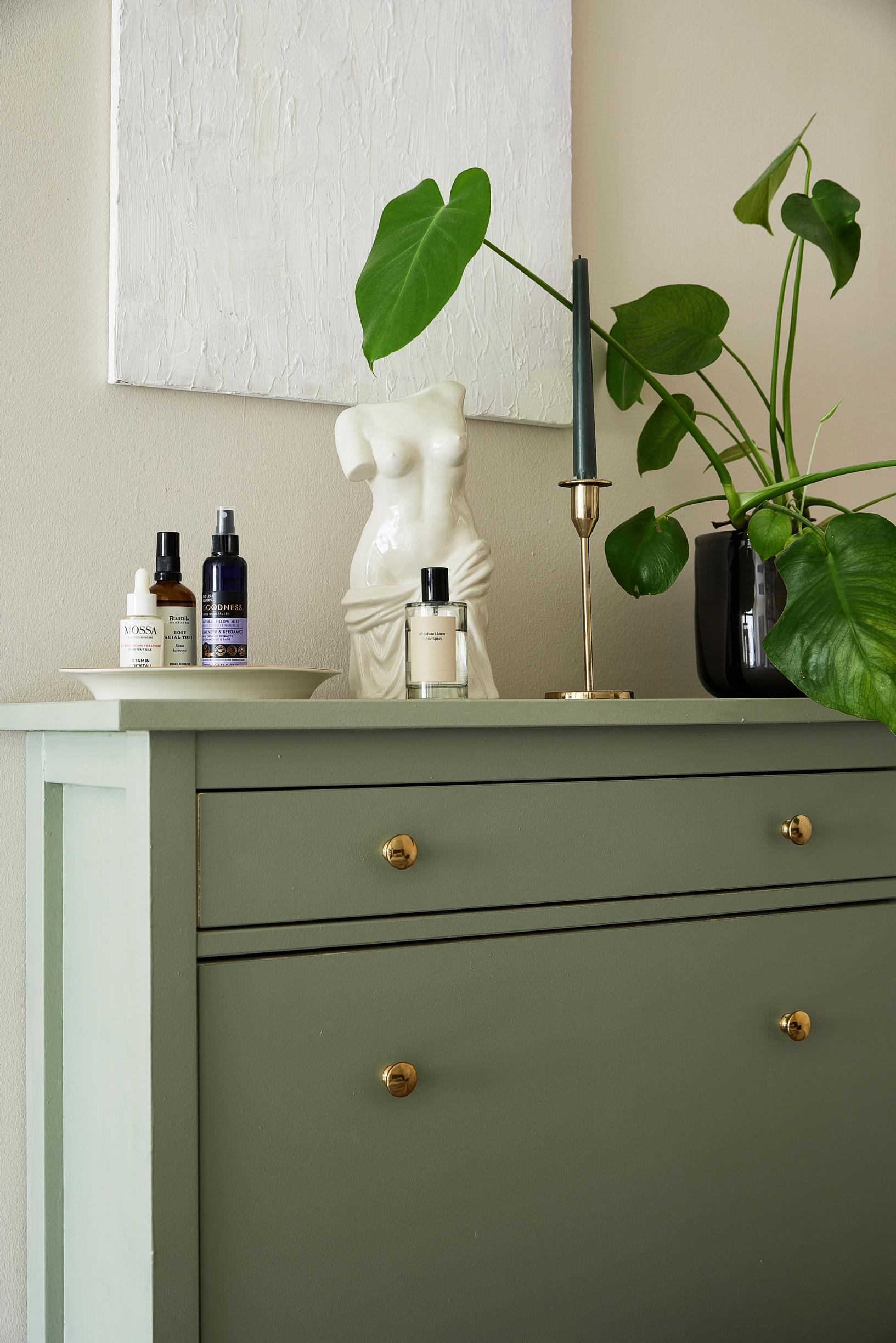 A shoe cabinet painted green