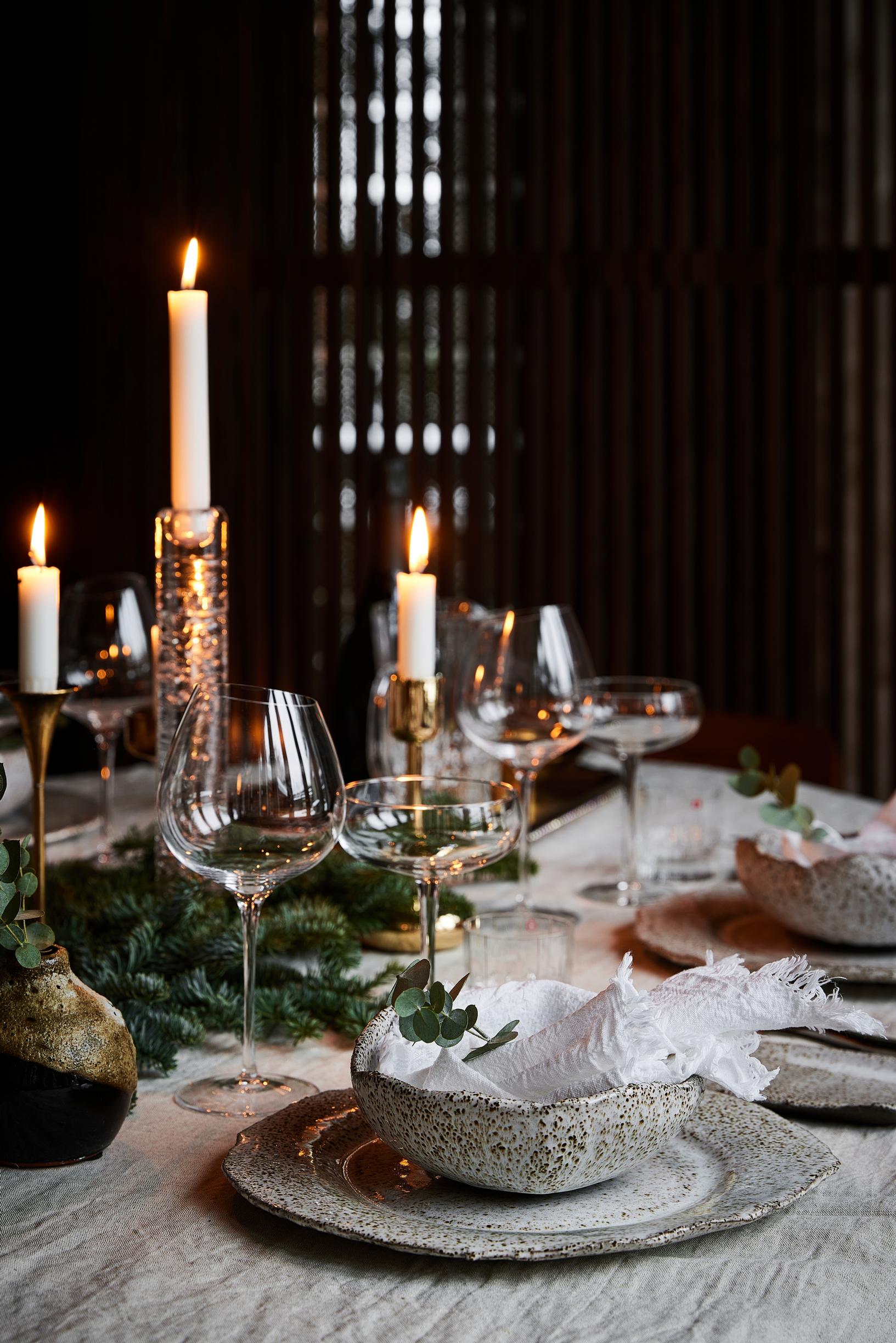 A holiday table set with custom ceramic dinnerware from a local pottery studio.
