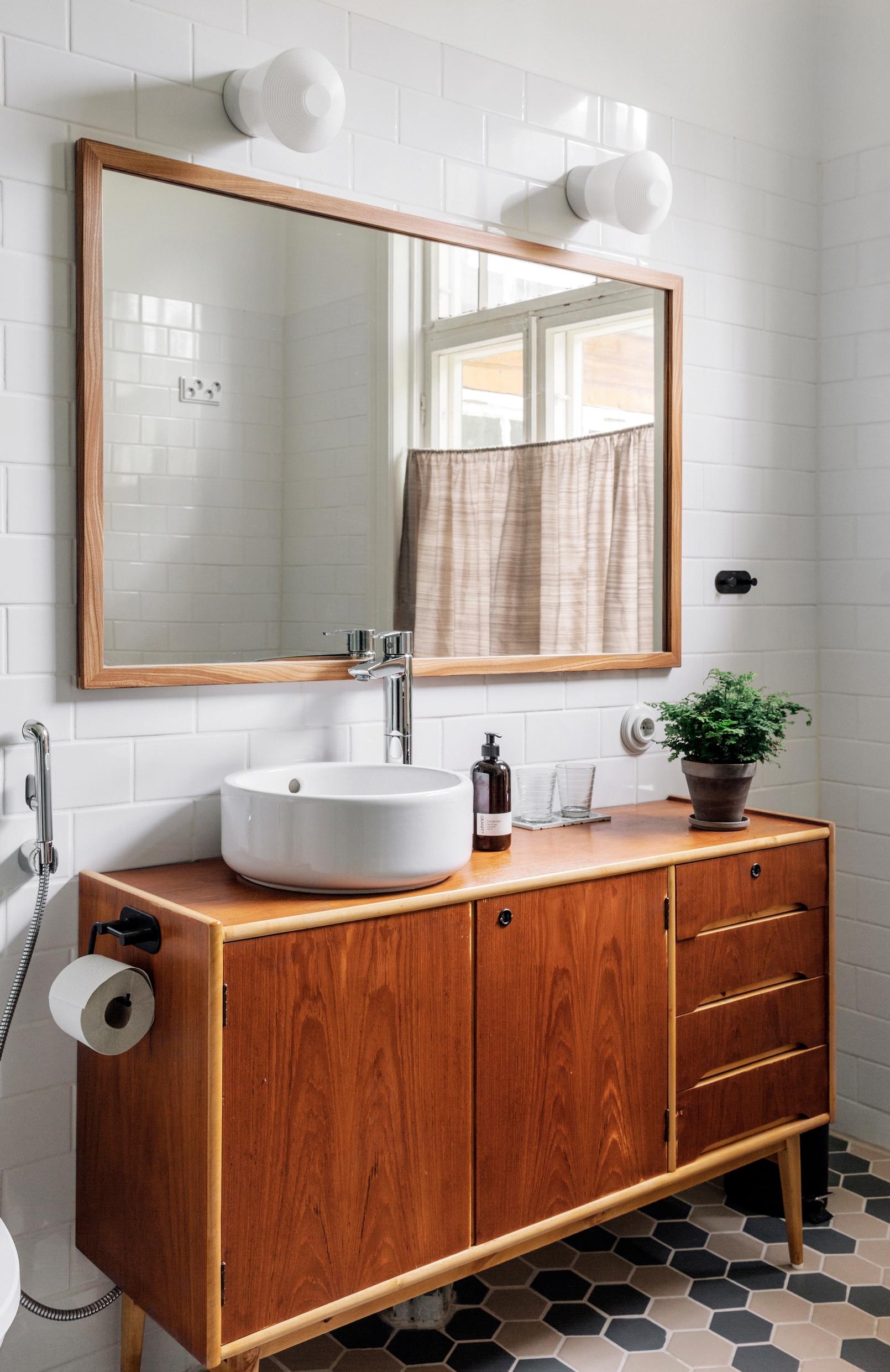 A 1950s sideboard coated with boat varnish, serving as a bathroom vanity top.