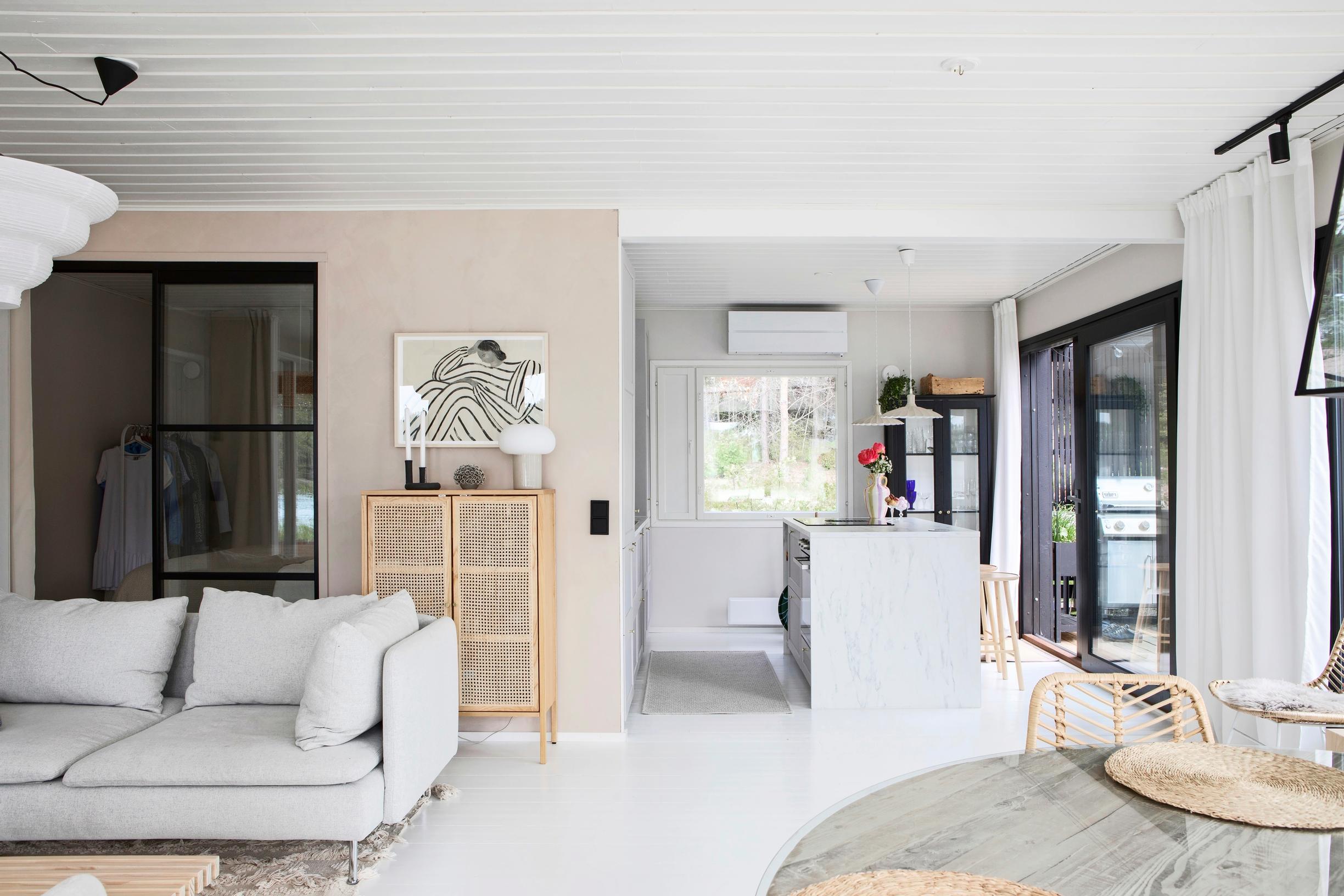 View from the spacious living area toward the kitchen and sleeping area