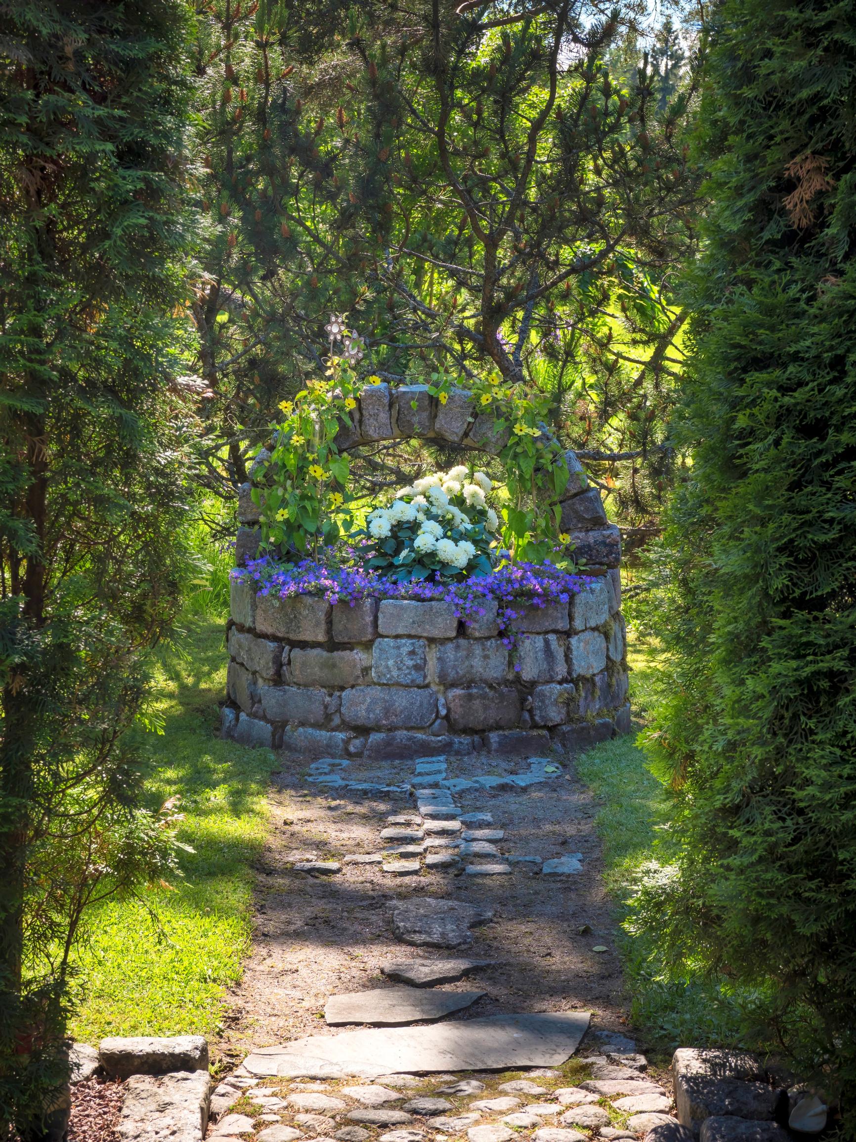 Summer flowers in the garden, stone flower basket