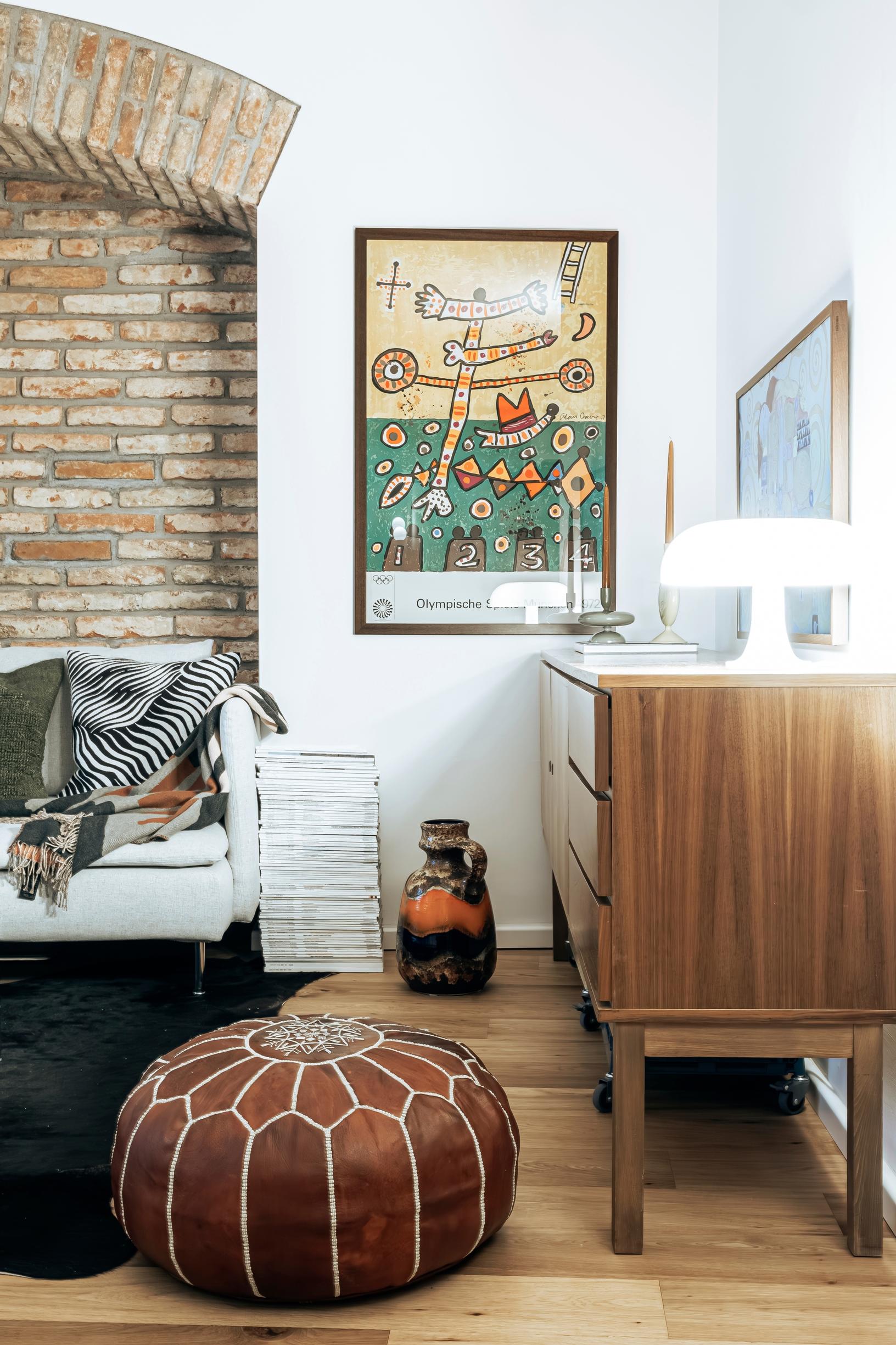 A Munich Olympics poster and a leather ottoman in the living room