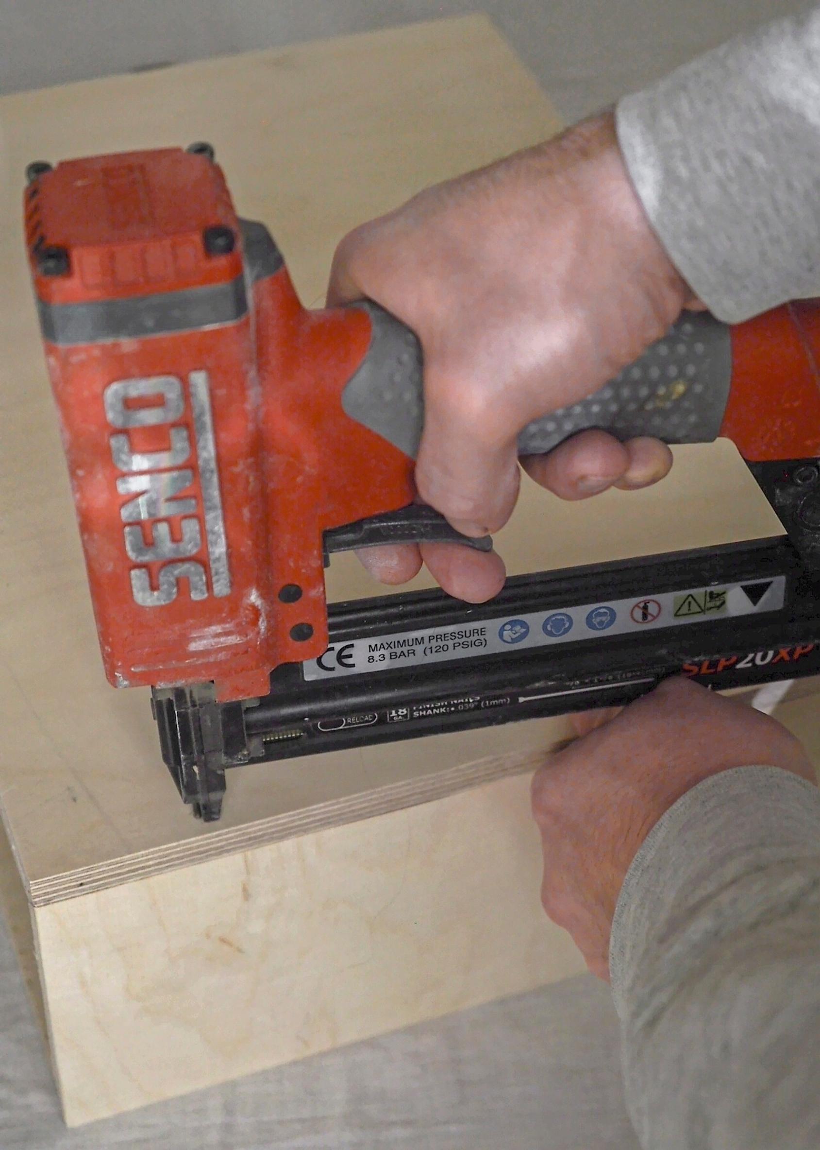 Attaching the bedside table drawer pieces with a nail gun