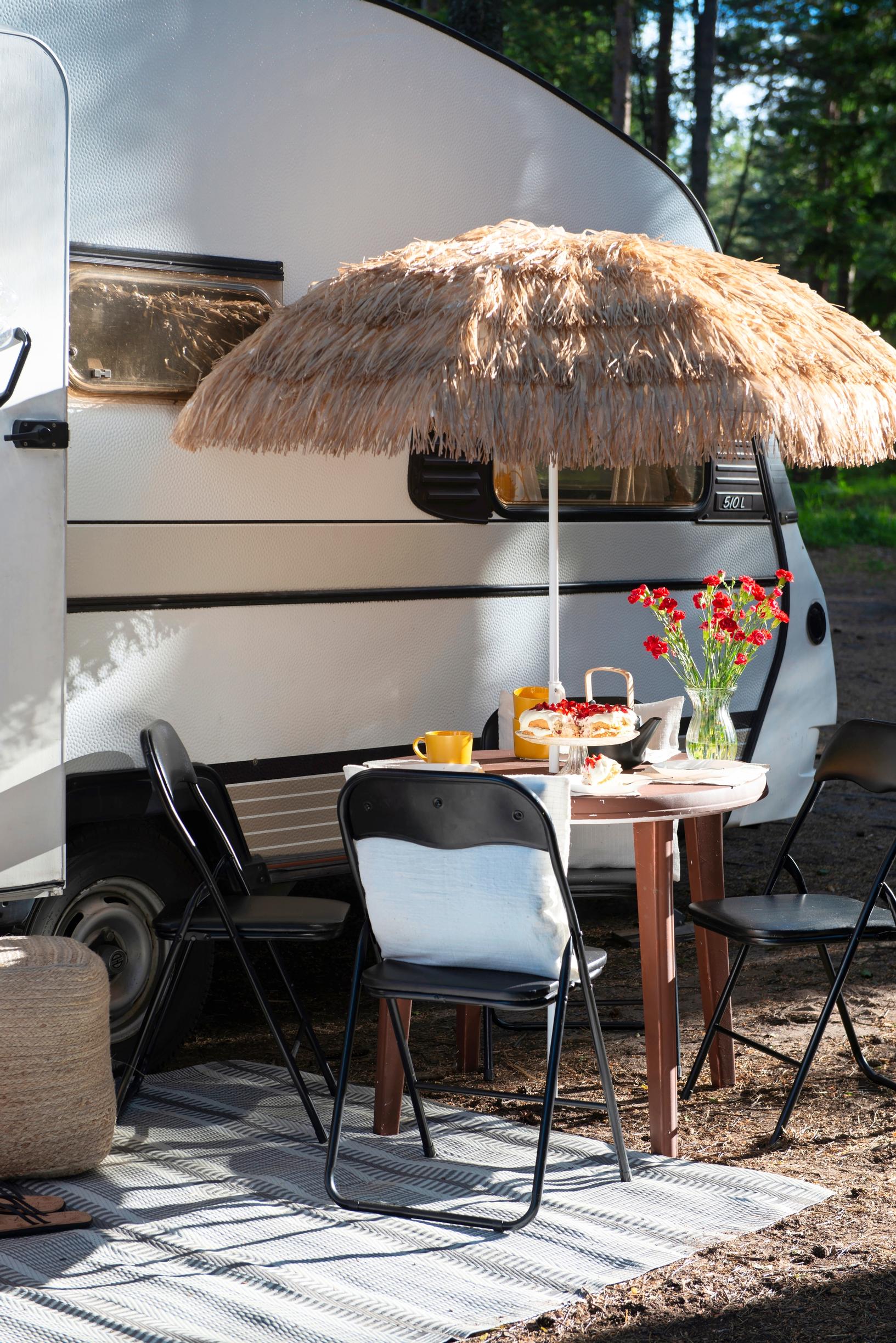 a patio set in front of the travel trailer