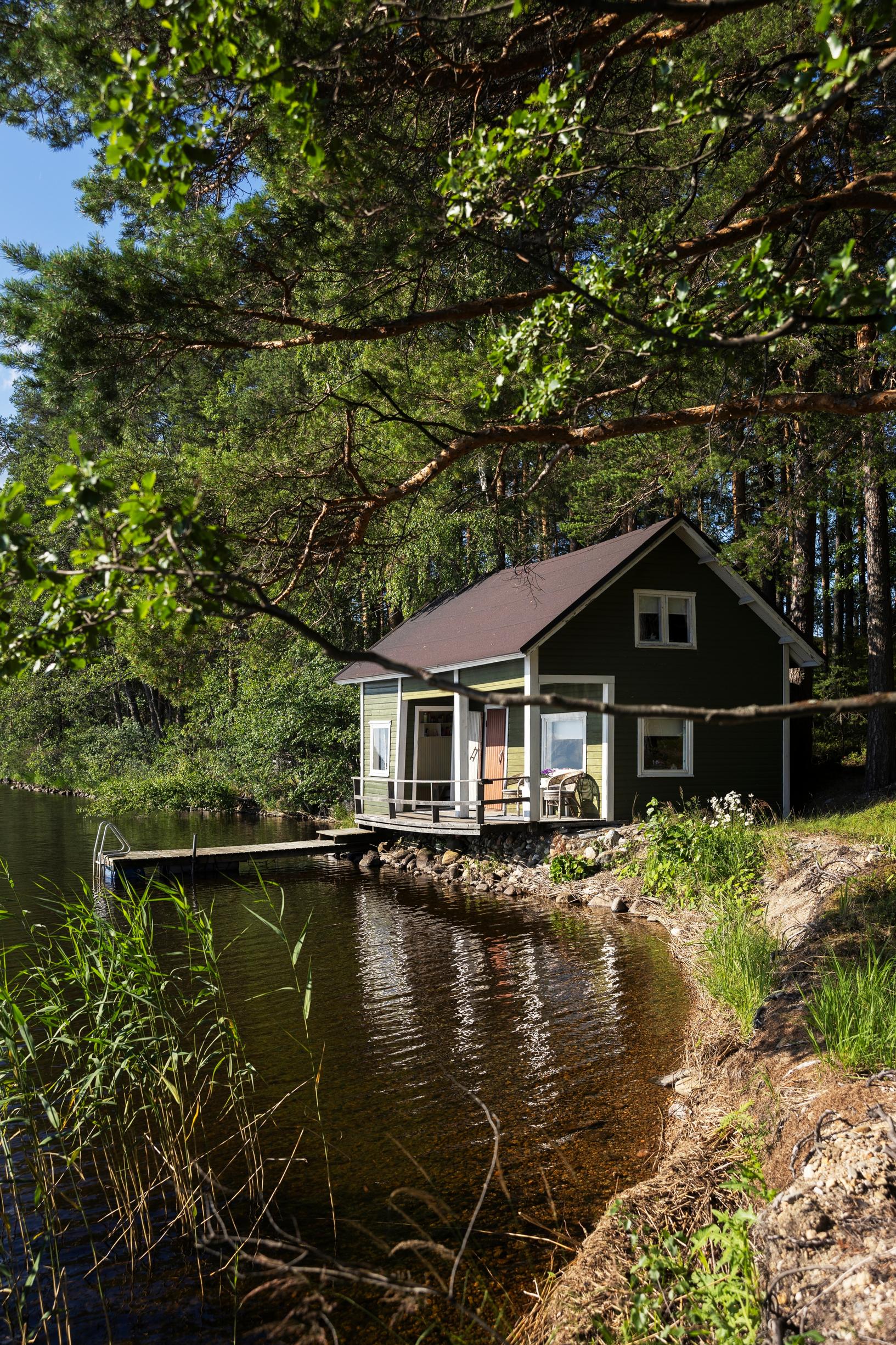 Sauna cottage in a cove with a dock, trees