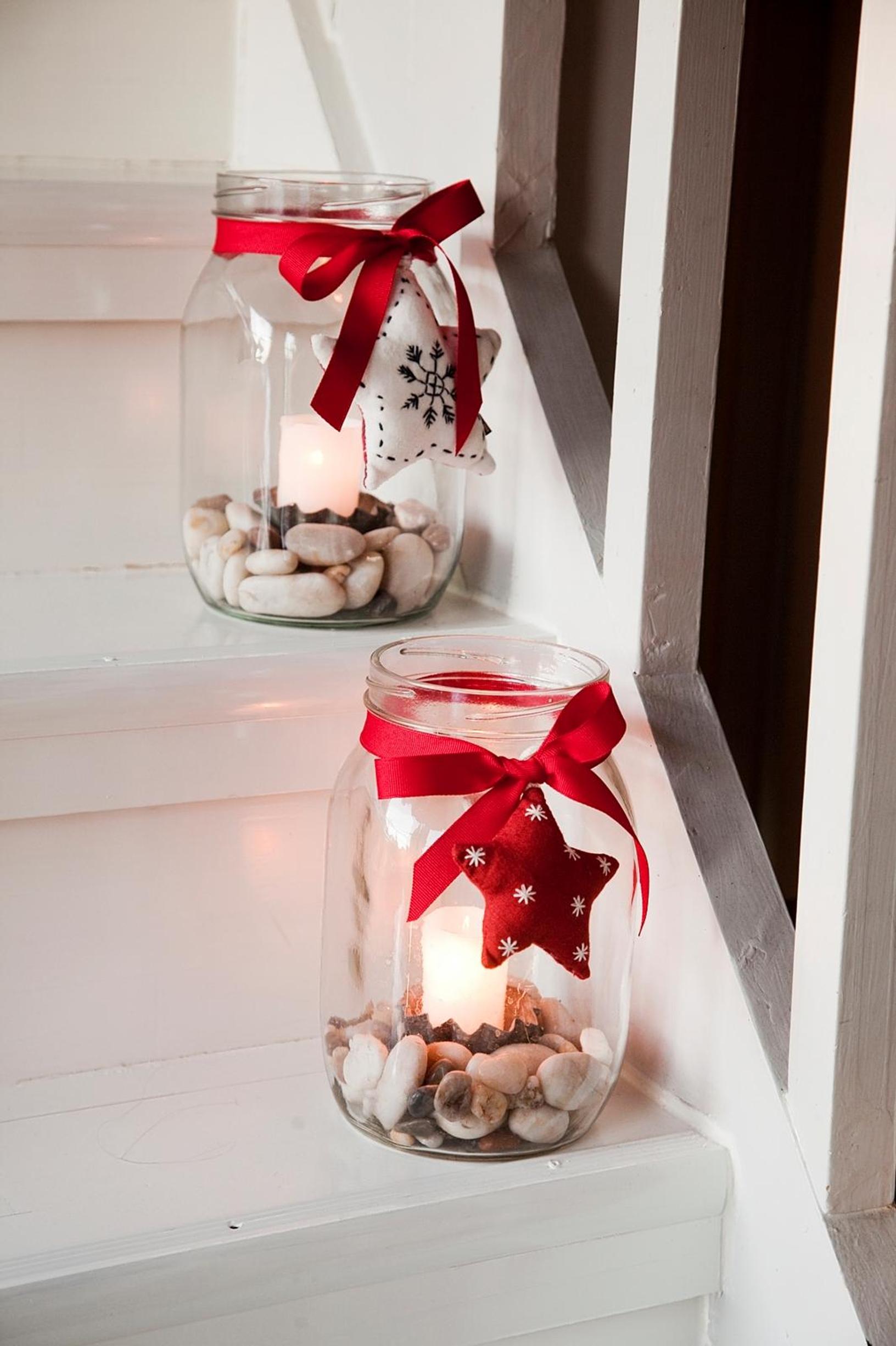 A glass jar filled with stones and candles