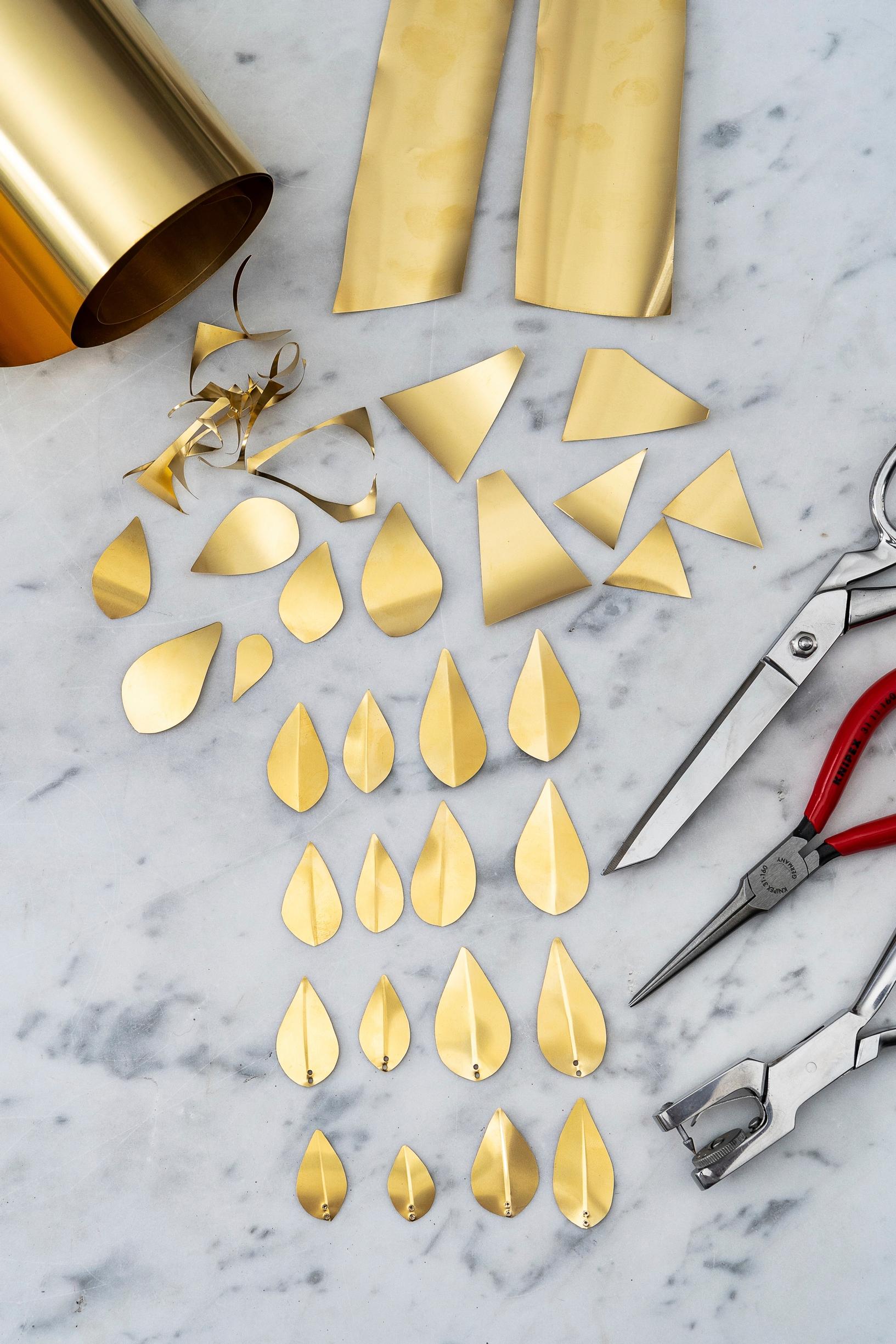 Leaf-shaped pieces cut from brass