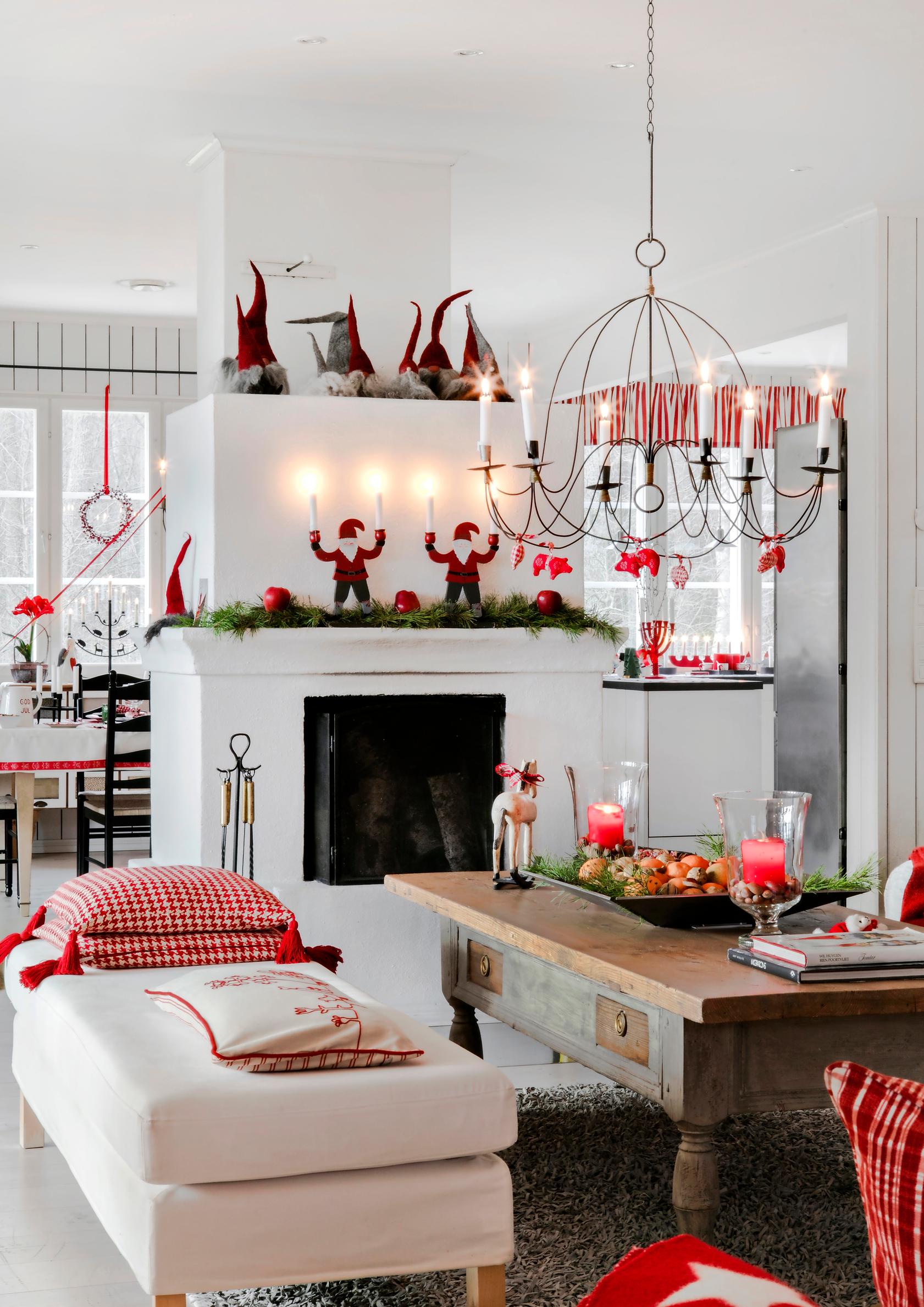 “There’s always room for one more elf”: Inger and Martti’s white home dazzles in red for Christmas