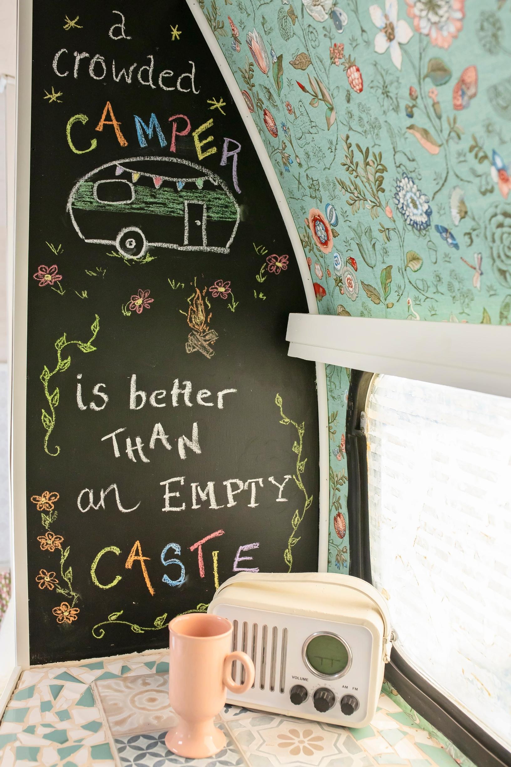A radio and chalkboard in the caravan