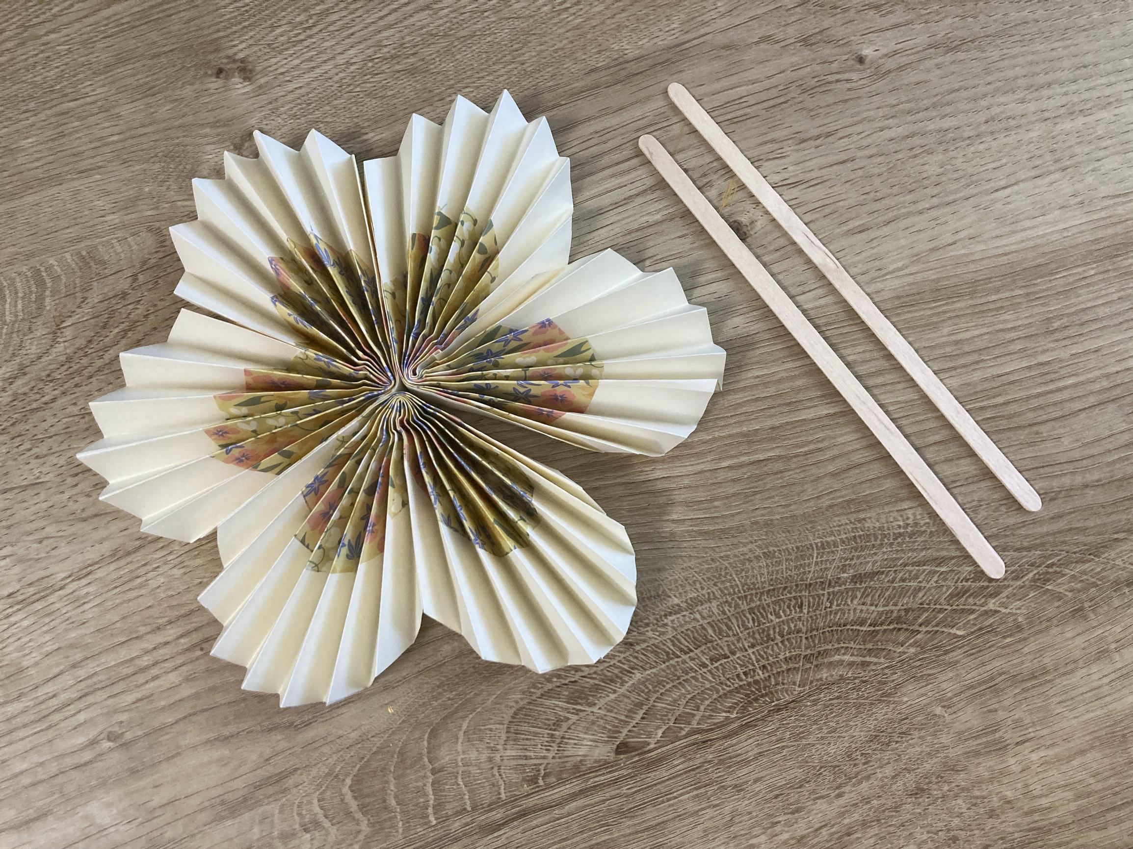 Step-by-step image showing the floral fan and craft sticks.