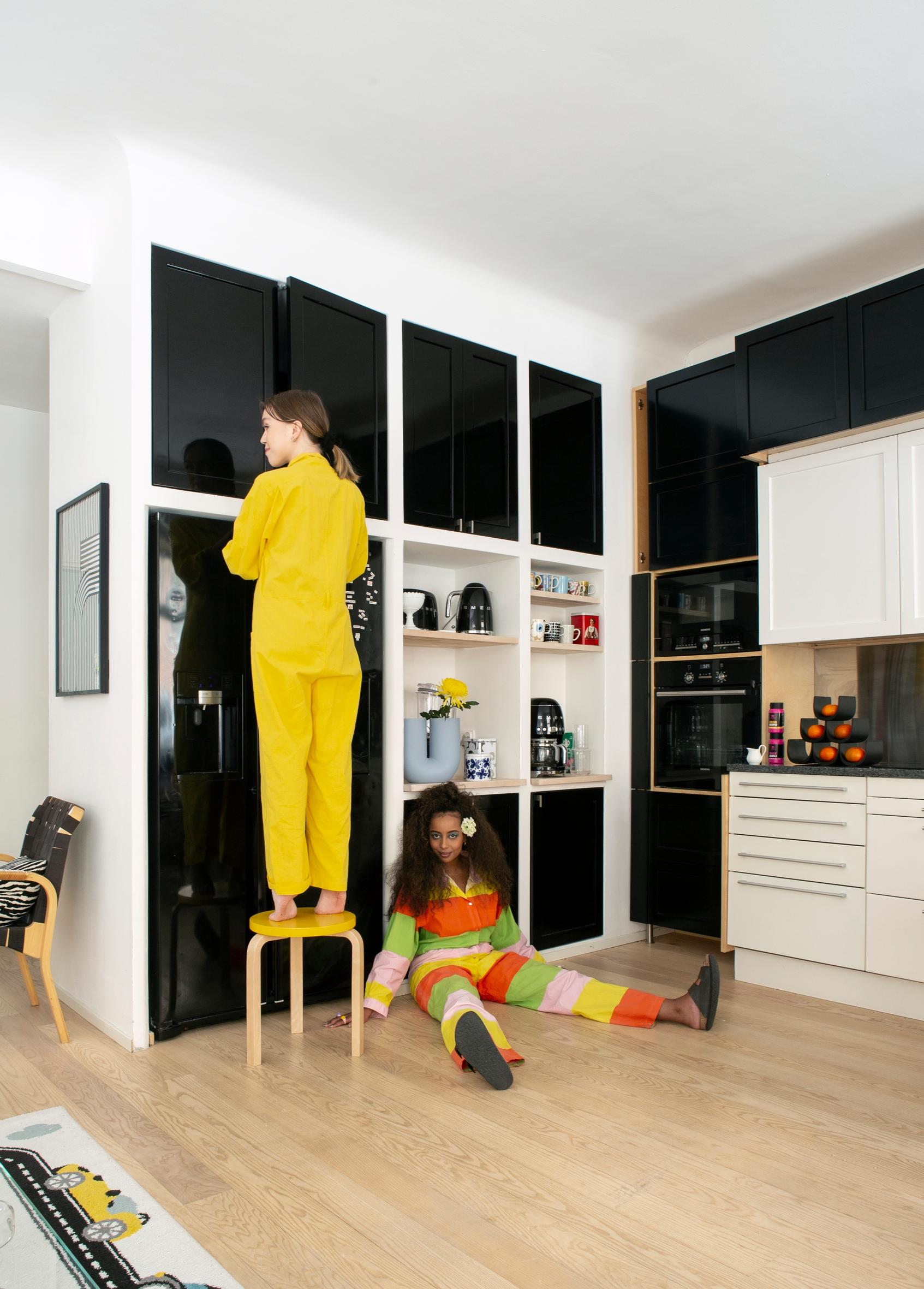 Hana and Vanessa in their black-and-white kitchen