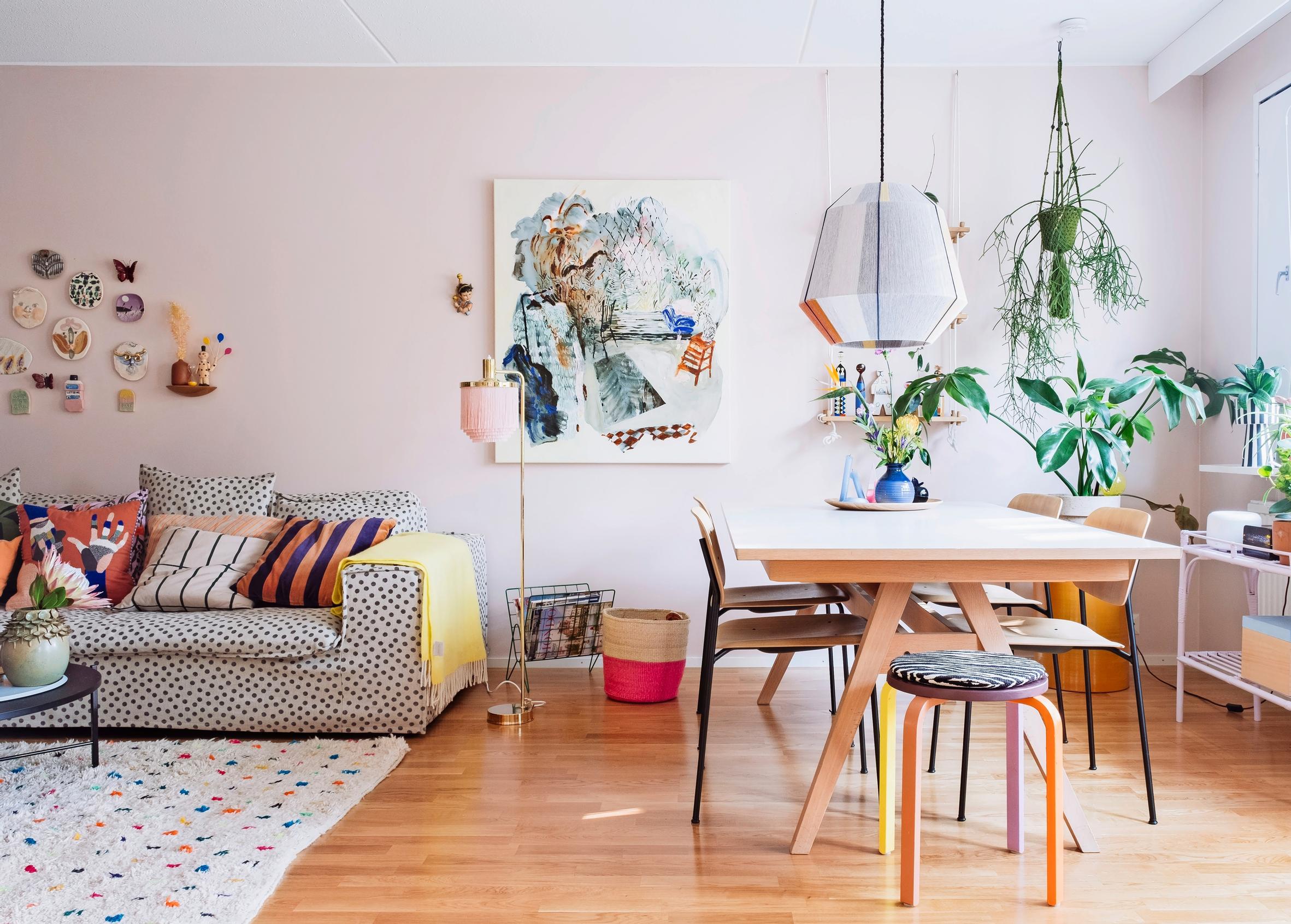 An open living area with bursts of color from art and textiles