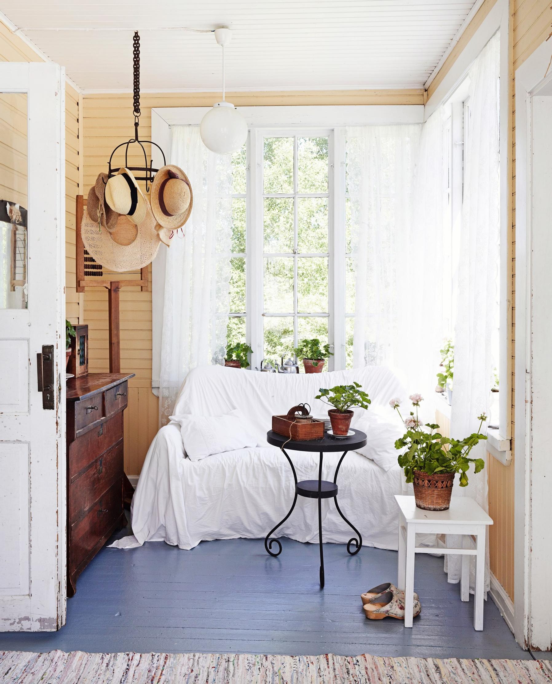 A yellow-walled glass porch