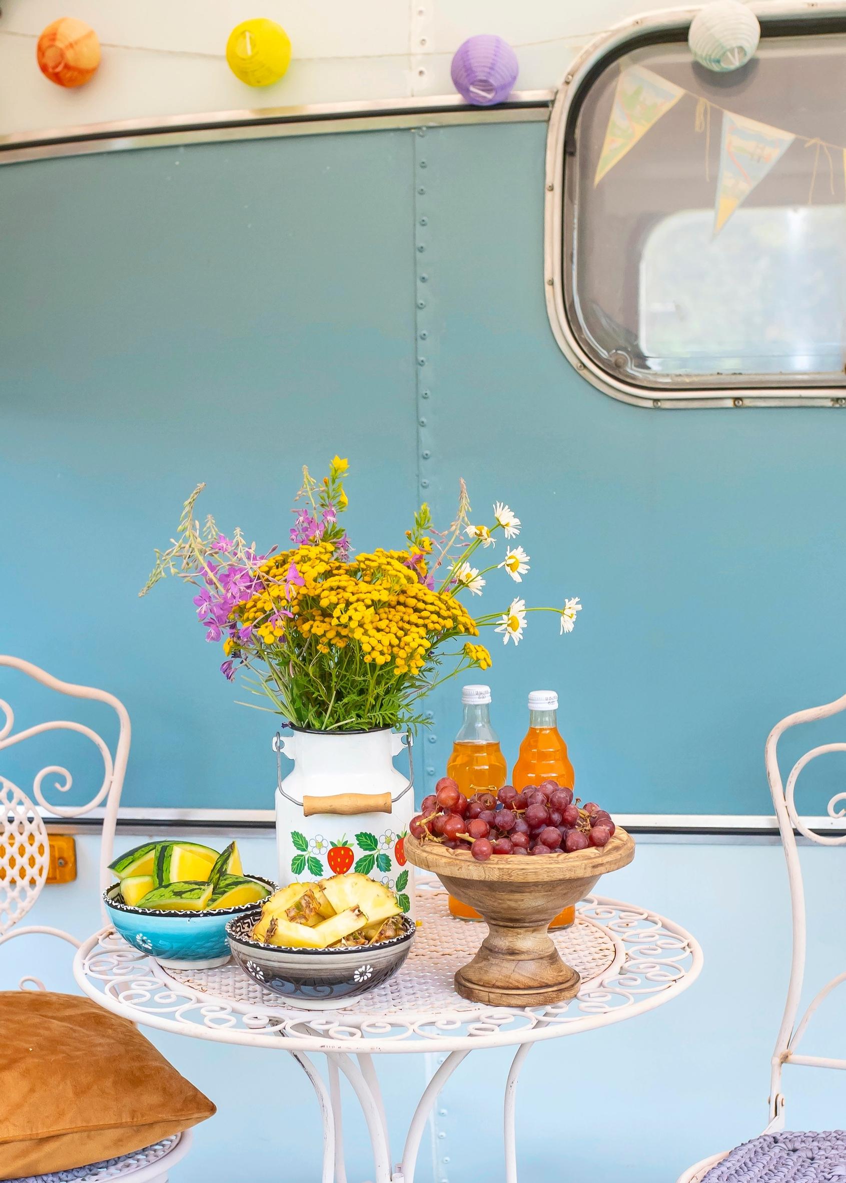Garden furniture in front of an old caravan