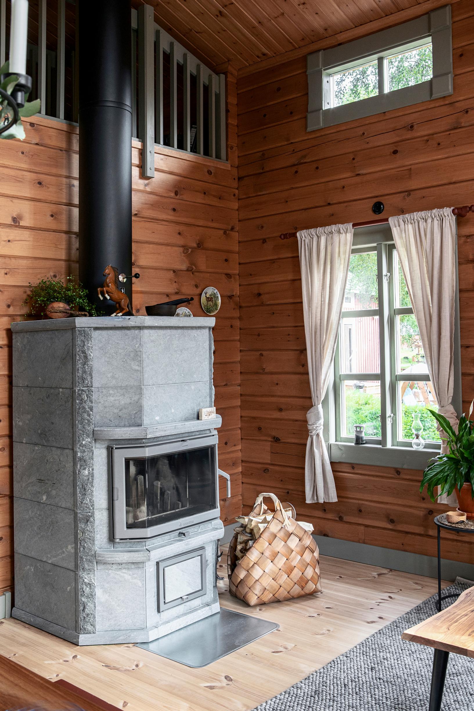 The soapstone fireplace heats the log house