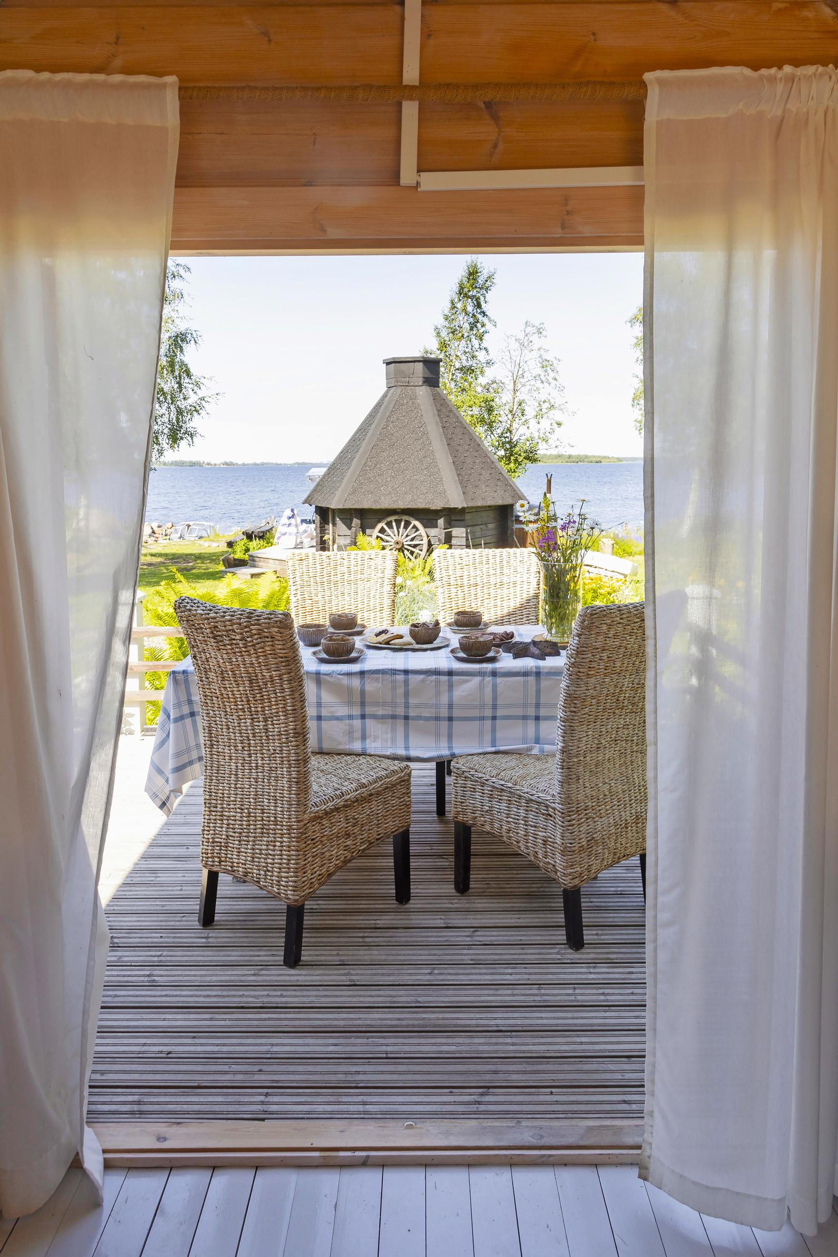 The terrace of Marita and Eki’s island cottage and a view of the sea