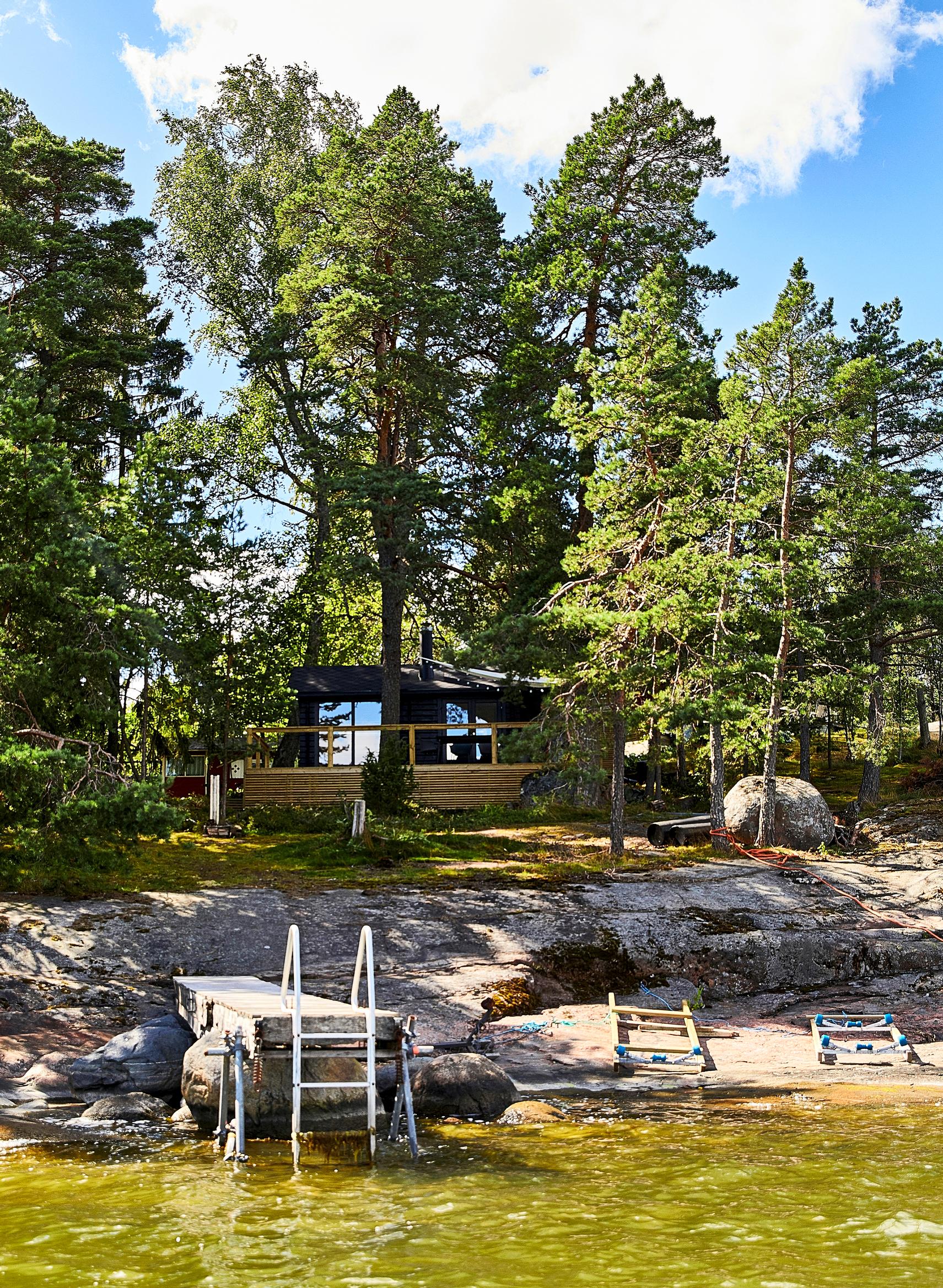 Modern black log cabin on an island