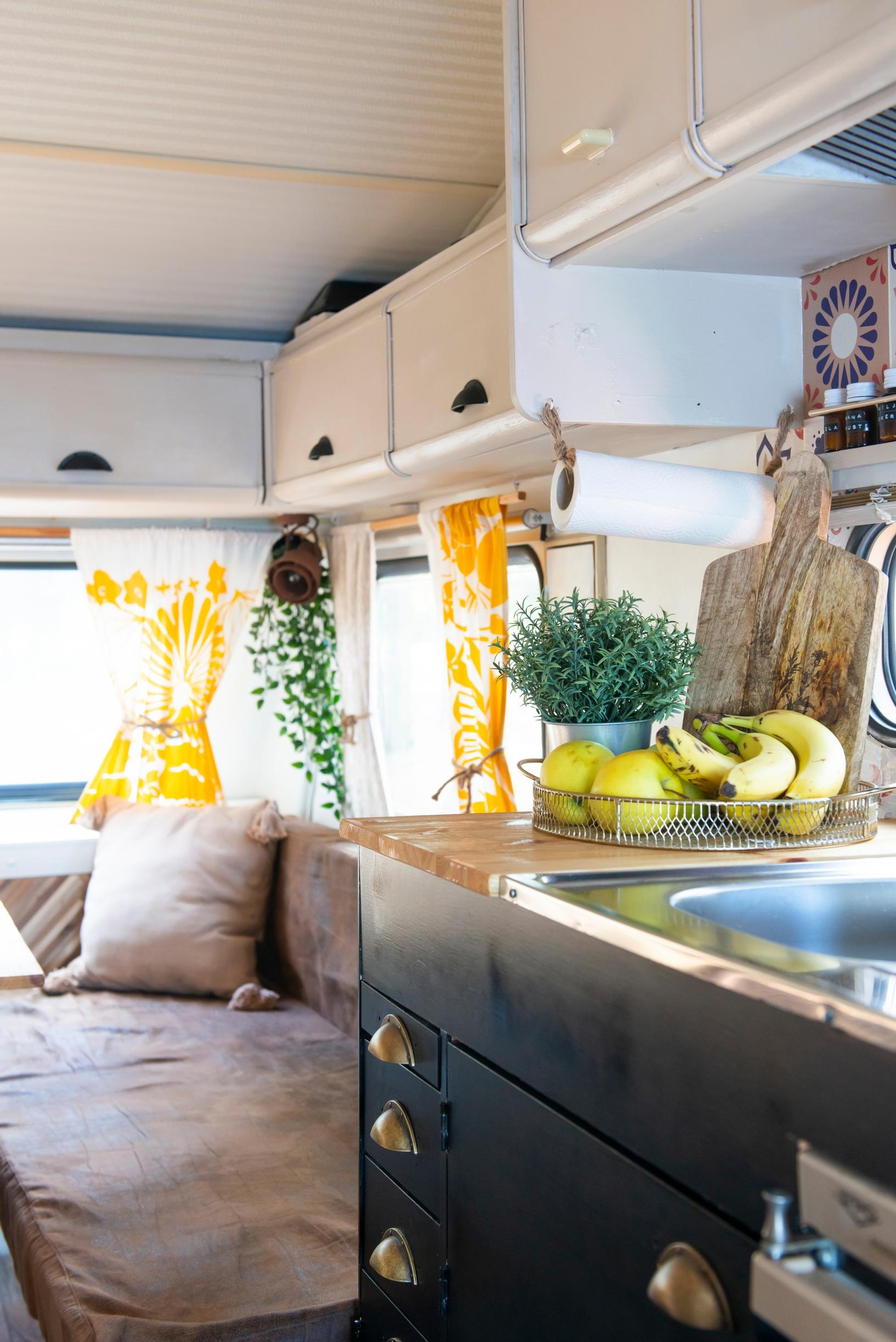 inside the trailer showing cabinets and a sofa