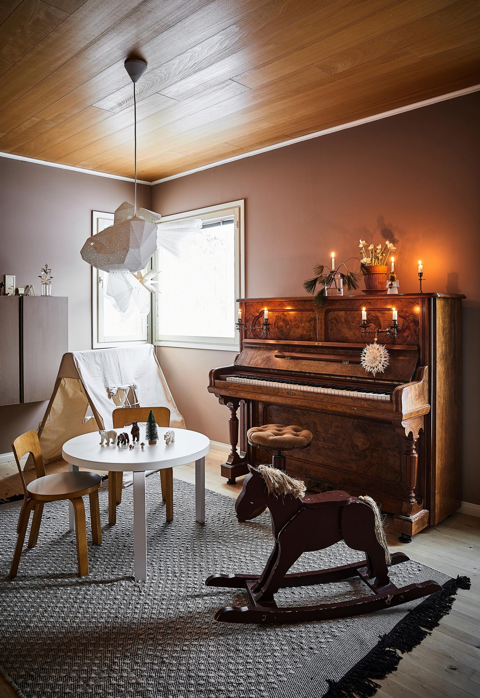 A rocking horse, old piano, children's play tent, and a small table set