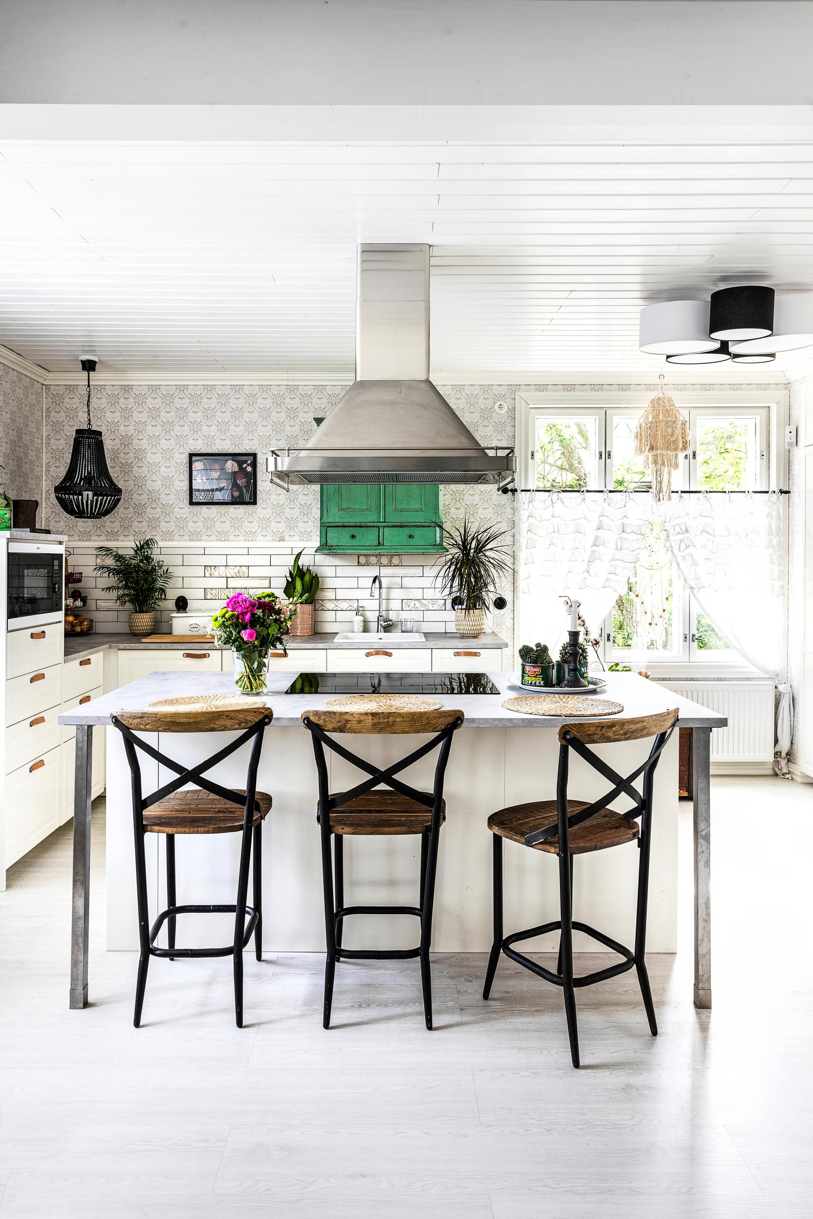 Dark wooden bar stools in a white kitchen