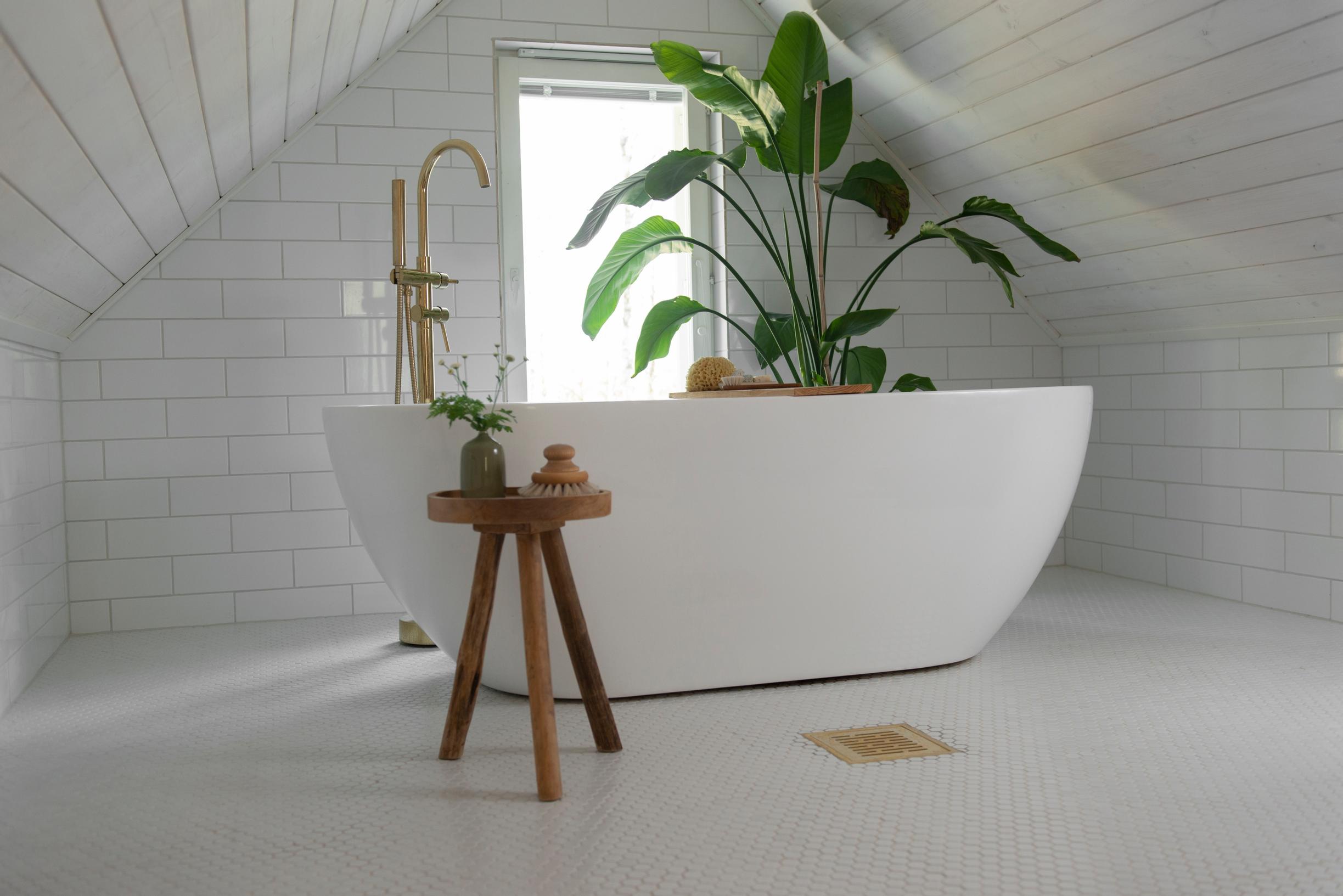Modern bathtub in a spacious bathroom under sloping ceilings