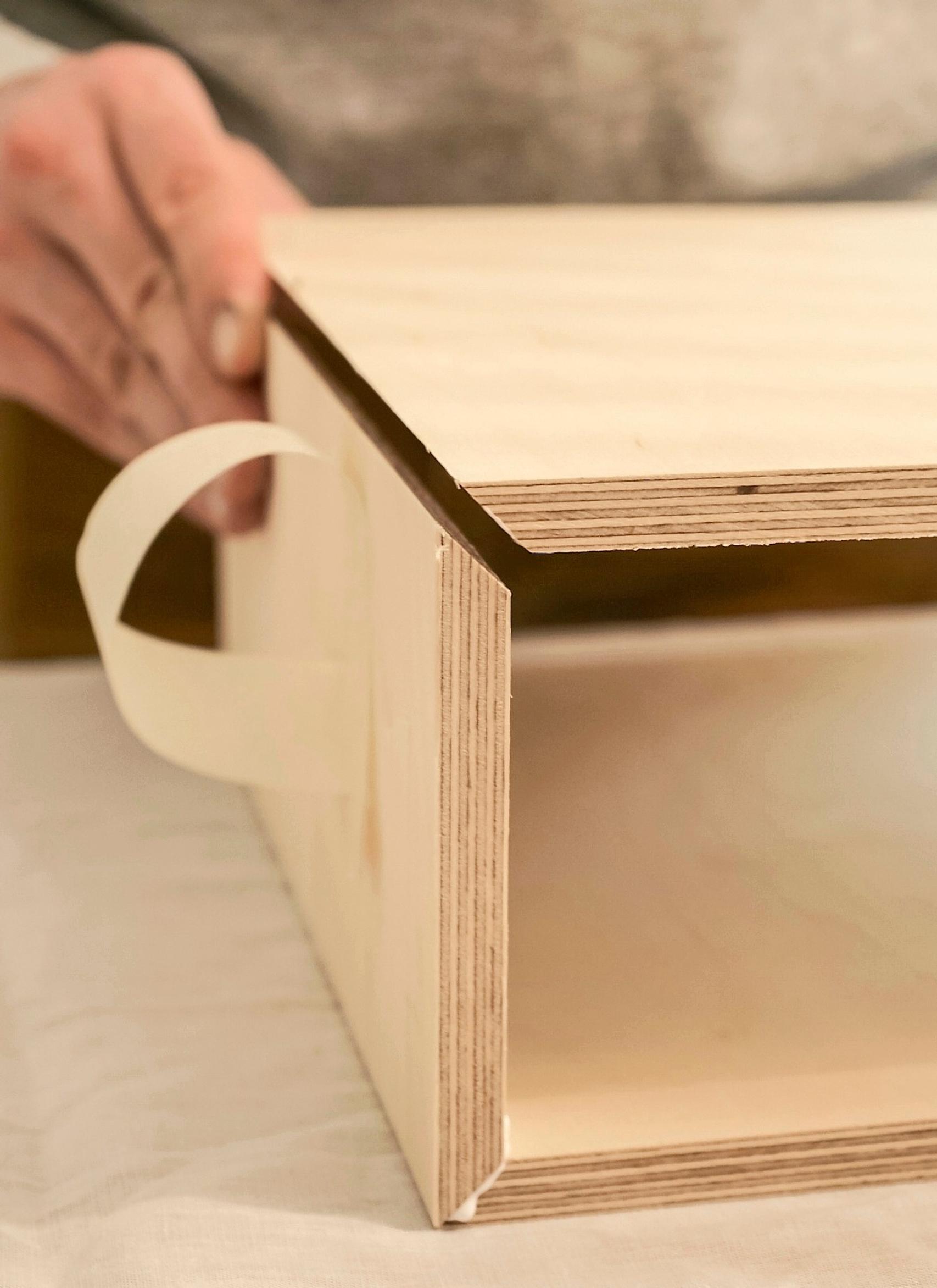 Gluing the bedside table’s mitered corners